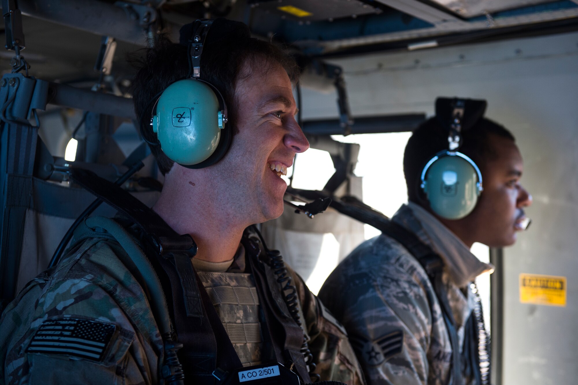 U.S. Air Force Master Sgt. Joel McPherson, 7th Air Support Operations Squadron uperintendent, shares a laugh with crewmembers, while traveling to the Oro Grande Training Complex in a U.S. Army Sikorsky UH-60 Black Hawk for the joint exercise, Iron Focus, Feb. 4, 2016. After completing Iron Focus, Army and Air Force units will head to the National Training Center in Fort Irwin, Calif. for four weeks prior to heading to their deployed location. (U.S. Air Force photo by Senior Airman Olivia Dominique/Released)