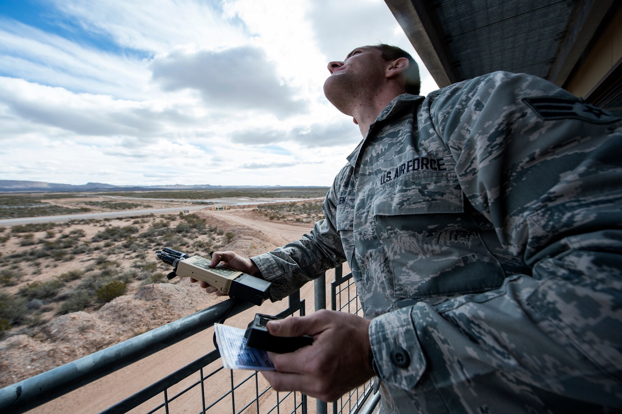 U.S. Air Force Senior Airman Jacob Mullen, 7th Air Support Operations Squadron joint terminal attack controller, scans the sky for a B-52 Stratofortress aircraft during the joint exercise, Iron Focus, Feb. 2, 2016, at Oro Grande Training Complex at Fort Bliss, Texas. During the exercise, JTACs honed their skills controlling aircraft in preparation for deployments. (U.S. Air Force photo by Senior Airman Olivia Dominique/Released)
