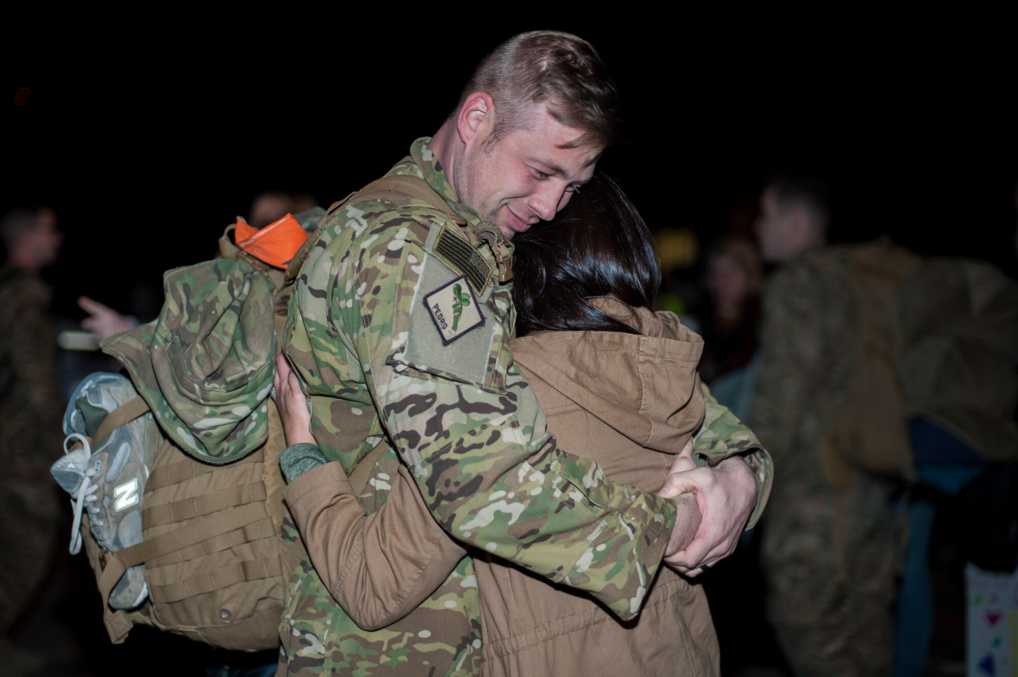 U.S. Air Force Capt. Howard Palmer, 41st Rescue Squadron pilot, embraces his wife, Julia, Feb. 10, 2016, at Moody Air Force Base, Ga. Palmer returned home after a combat search and rescue deployment in Southwest Asia. (U.S. Air Force photo by Airman 1st Class Lauren M. Johnson/Released)