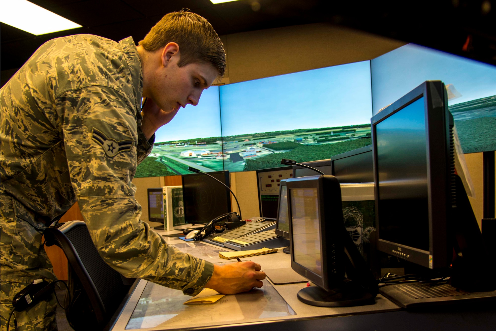Airman 1st Class Christian Darr, 375th Operations Support Squadron air traffic control apprentice, taxis aircraft out to the runway during a simulated training exercise at the Scott Air Force Base air control tower Feb. 5.  Before receiving the simulator, air traffic controllers conducted exercises using a map of the area with wooden airplanes to represent the locations of the aircraft.  Now trainees can adjust different elements within an exercise, including the number of aircraft or ground vehicles, runway closures, emergency situations and mishaps for example. (U.S. Air Force photo/Airman Daniel Garcia)