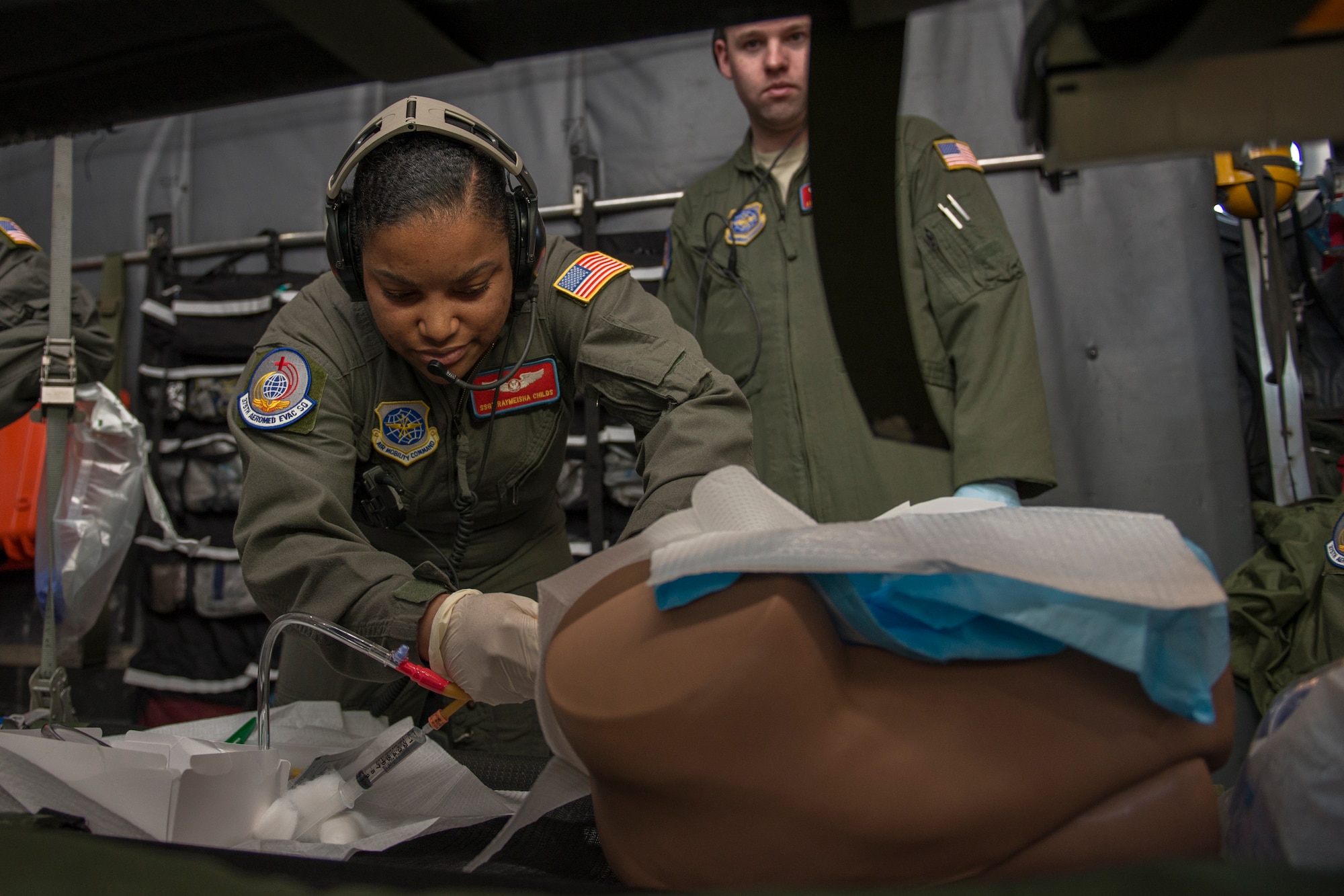 Staff Sgt. Raymeisha Childs, 375th Aeromedical Evacuation Squadron technician, places a catheter in a mannequin during training in a simulated C-130 Hercules fuselage Jan. 28, 2016, Scott Air Force Base, Illinois. The fuselage provides the 375th AES the opportunity to accomplish 50 percent of their required semi-annual training. (U.S. Air Force photo by Airman 1st Class Melissa Estevez)