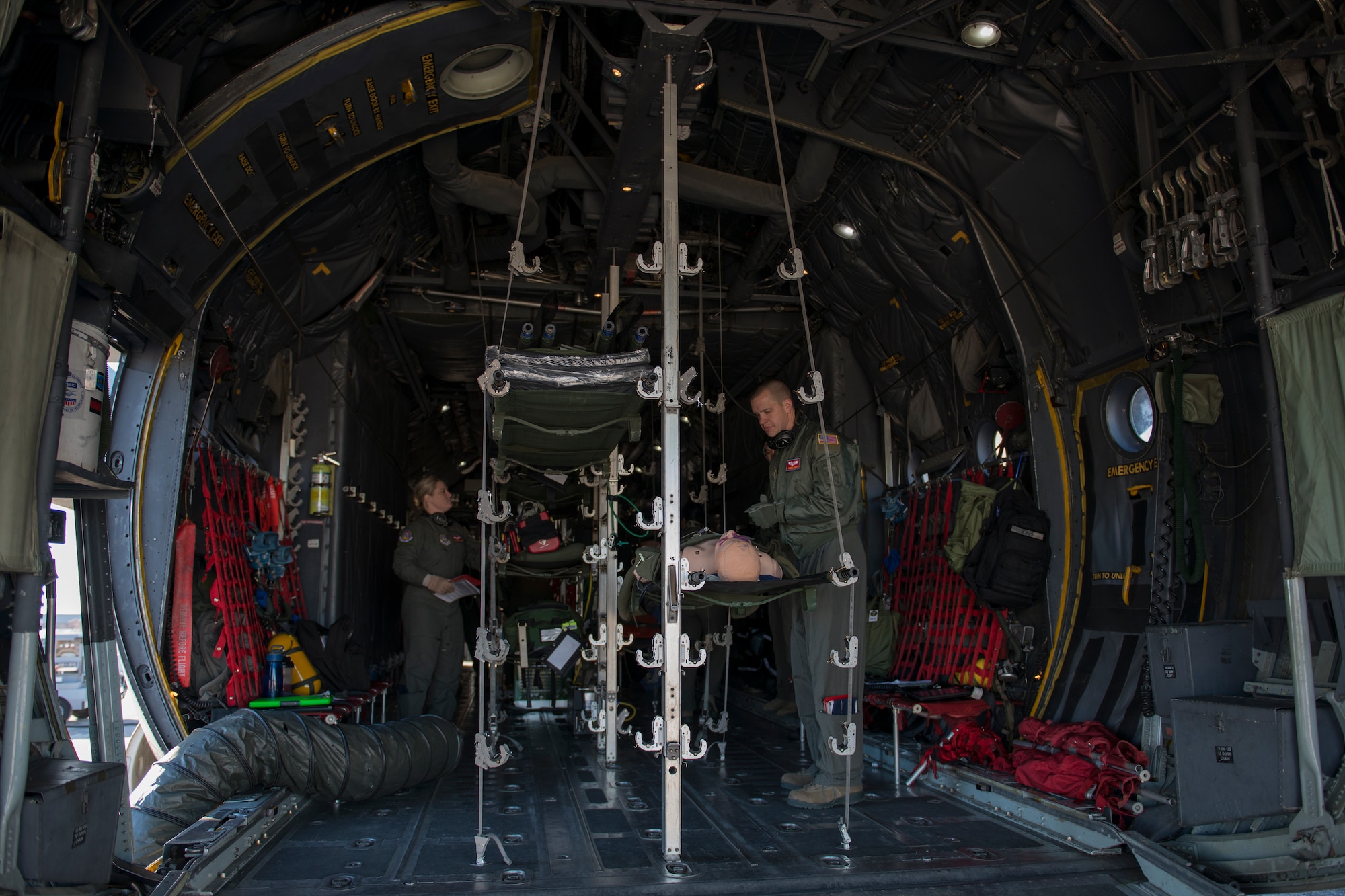 375th Aeromedical Evacuation Squadron Airmen conduct medical and operational training in a simulated C-130 Hercules fuselage Jan. 28, 2016, Scott Air Force Base, Illinois. The C-130 Hercules fuselage was rescued from the bone yard and is used to keep the aircrew's skills sharp. (U.S. Air Force photo by Airman 1st Class Melissa Estevez)