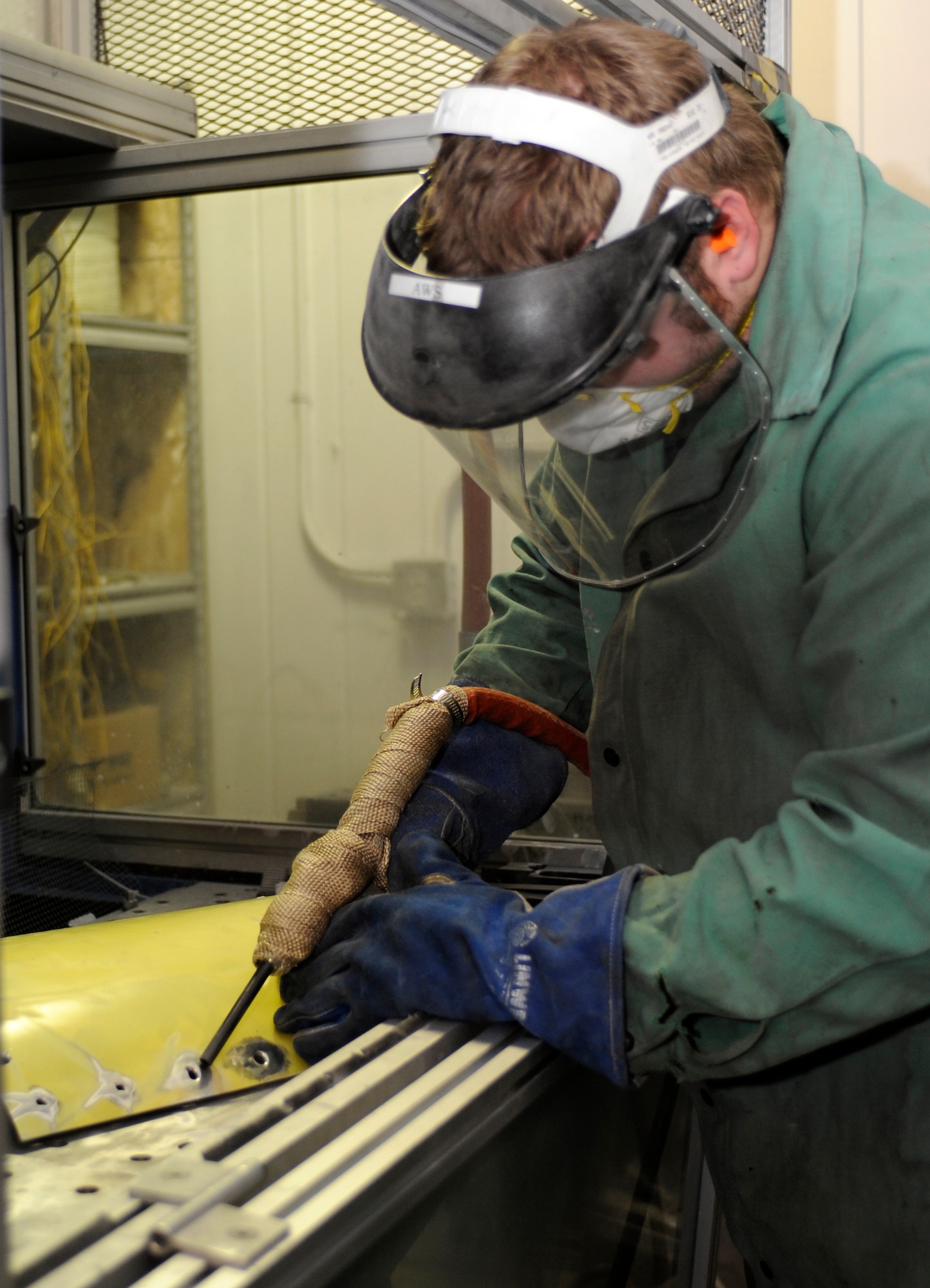 A South Dakota School of Mines and Technology student demonstrates the cold spray repair process on an aircraft panel at the SDSMT in Rapid City, S.D., Jan. 31, 2013. Following a partnership with the school and other agencies, Ellsworth AFB personnel have been using this technology for more than two-years and the 28th Maintenance Group is expanding the capability by building a cold spray facility, slated to be fully operational in May 2016. (U.S. Air Force photo by Airman Ashley J. Thum/Released)