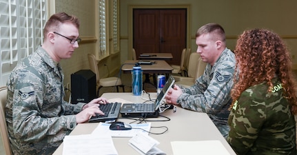 Tech. Sgt. Latoya Johnson-Mallory, 628th Legal Office paralegal, assists Joint Base Charleston members with their tax returns Feb. 9, 2016, at the Charleston Club on JB Charleston – Air Base, S.C. The Airmen working the tax center are able to provide tax return assistance to all active-duty, retirees and their dependents. (U.S. Air Force photo/Senior Airman Clayton Cupit)
