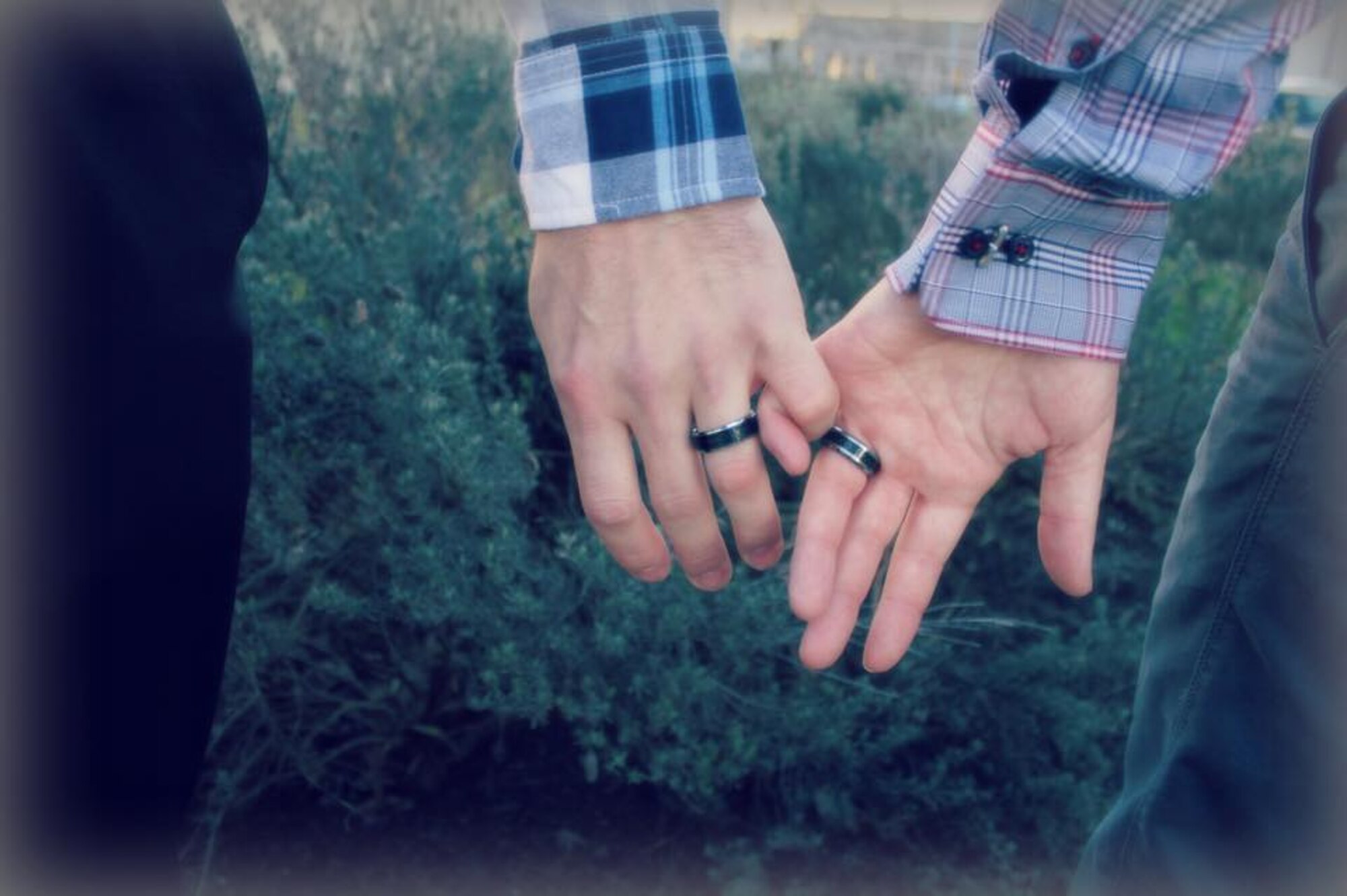 Staff Sgt. Ryan Stimer, 48th Operations Support Squadron air traffic control watch supervisor, and his husband, Staff Sgt. Steven Marking, 436th OSS ATC watch supervisor, hold hands after getting married in Tacoma, Wash., Feb. 17, 2015. Stimer and Marking have been in a two-year long distance relationship since early 2014, and will be stationed together at Dover Air Force Base, Del., Feb 12, 2016. (Courtesy photo)