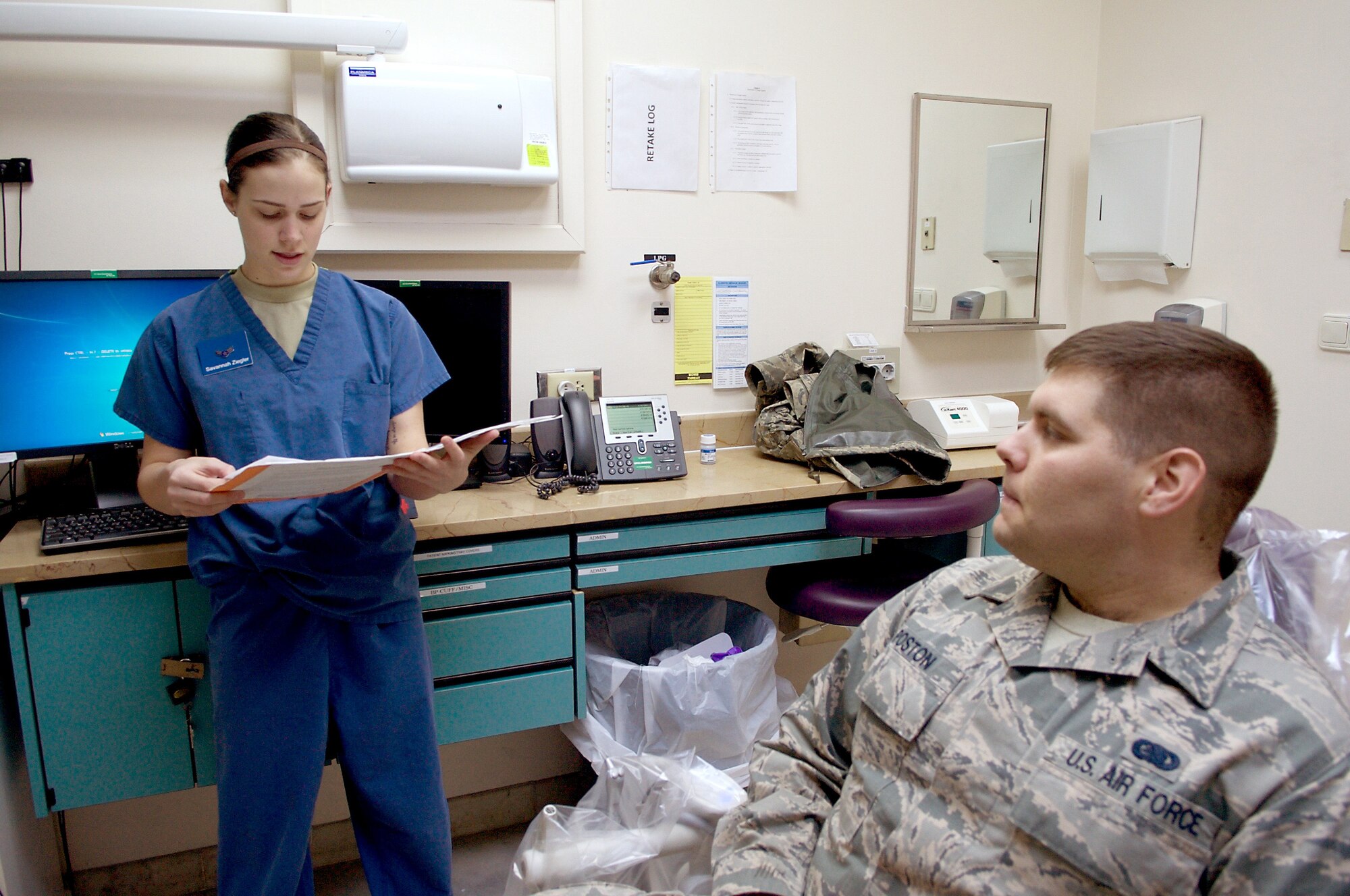 U.S. Air Force Airman 1st Class Savannah Ziegler, 39th Medical Operations Squadron dental technician, verifies patient information with her patient Senior Airman Charles Poston, 39th Logistics Readiness Squadron fuels fixed facilities technician, before beginning a dental procedure Jan. 28, 2016, at Incirlik Air Base, Turkey.  Positive patient identification ensures there are no mix-ups between patients or procedures. (U.S. Air Force photo by Staff Sgt. Jack Sanders/Released)