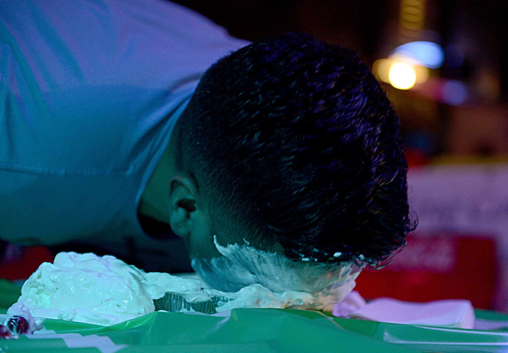 Senior Airman Daniel Zamora, 724th Aircraft Maintenance Squadron, participates in a cherry-finding contest Feb. 7, 2016, in the Ramstein Enlisted Club, at Ramstein Air Base, Germany. The 86th Force Support Squadron hosted the party at the Ramstein Enlisted Club to give service members, Department of Defense civilians and family members the opportunity to watch the game. (U.S. Air Force photo/Staff Sgt. Timothy Moore)