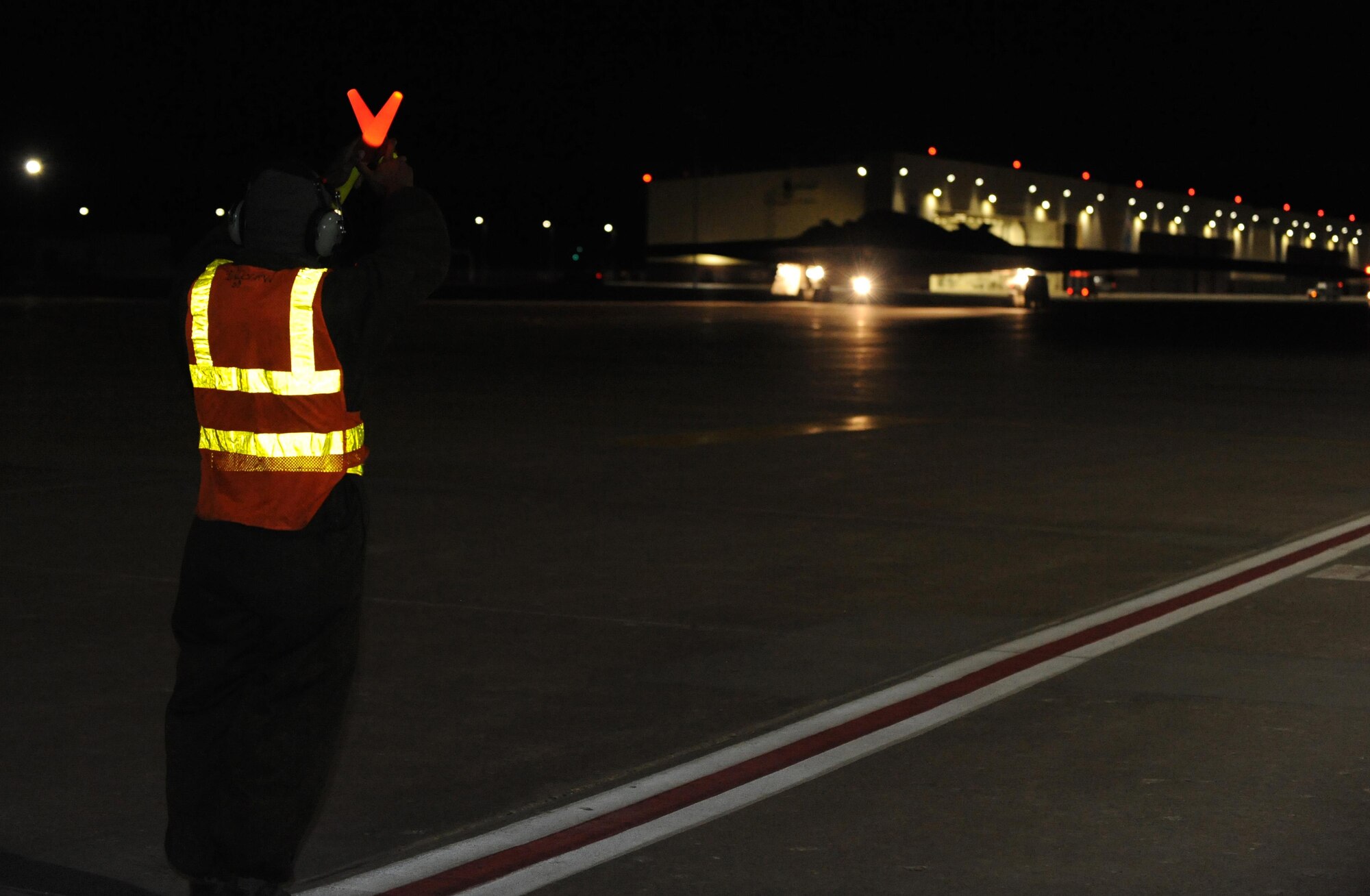 U.S. Air Force Airman First Class Andrew Dutton, a 509 Aircraft Maintenance Squadron crew chief, marshals a B-2 Spirit down the flightline at Whiteman Air Force Base, Mo., Feb. 2, 2016, prior to take off during Red Flag (RF) 16-1. RF, located at Nellis AFB, Nev., is one of a series of advanced training programs administered by the USAF Warfare Center and executed by the 414th Combat Training Squadron. (U.S. Air Force photo by Tech. Sgt. Miguel Lara III)