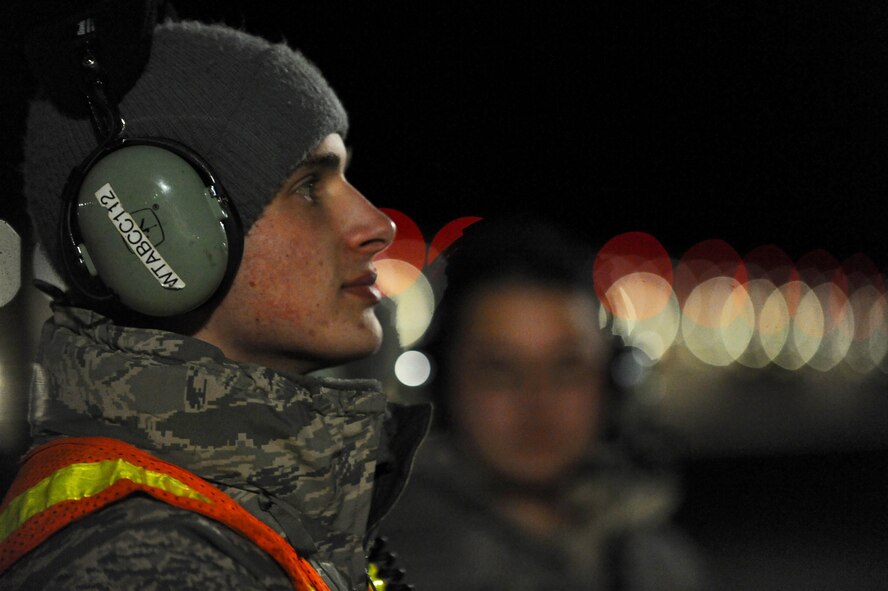 U.S. Air Force Airman 1st Class Andrew Dutton, a 509th Aircraft Maintenance Squadron crew chief, waits for pre-flight instructions over his headset at Whiteman Air Force Base, Mo., Feb. 2, 2016, during Red Flag (RF) 16-1. RF, located at Nellis AFB, Nev., enables joint and international units to sharpen their combat skills by flying simulated combat sorties in a realistic environment. (U.S. Air Force photo by Tech. Sgt. Miguel Lara III))