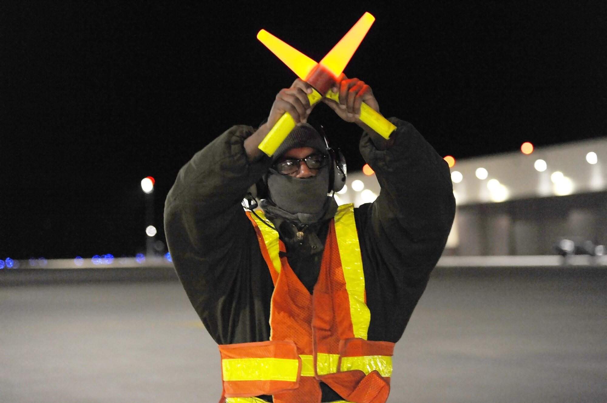 U.S. Air Force Senior Airman Detroy Brooks, a 509th Aircraft Maintenance Squadron crew chief, marshals a B-2 Spirit aircraft at Whiteman Air Force Base, Mo., Feb. 2, 2016. Crew chiefs play a vital role in ensuring traffic safety on the flightline while aircraft taxi before takeoff. (U.S. Air Force photo by Airman 1st Class Michaela R. Slanchik)