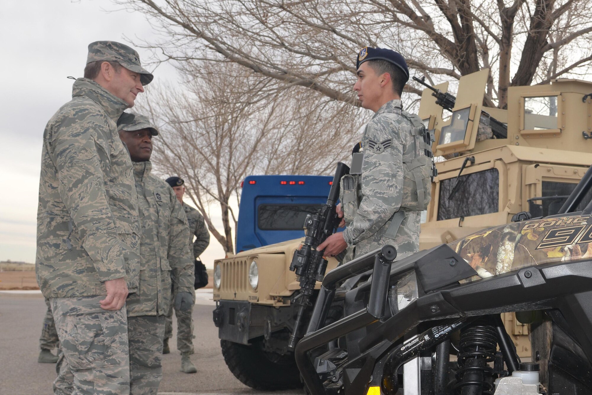 Gen. Robin Rand, Air Force Global Strike Command commander, and Chief Master Sgt. Calvin Williams, AFGSC command chief, learn from security specialist Senior Airman Isaac Gonzalez about the 377th Weapons System Security Squadron. Rand was at Kirtland Air Force Base Feb. 4-5 to meet with Airmen and learn more about the base's missions. (U.S. Air Force photo by Todd R. Berenger)