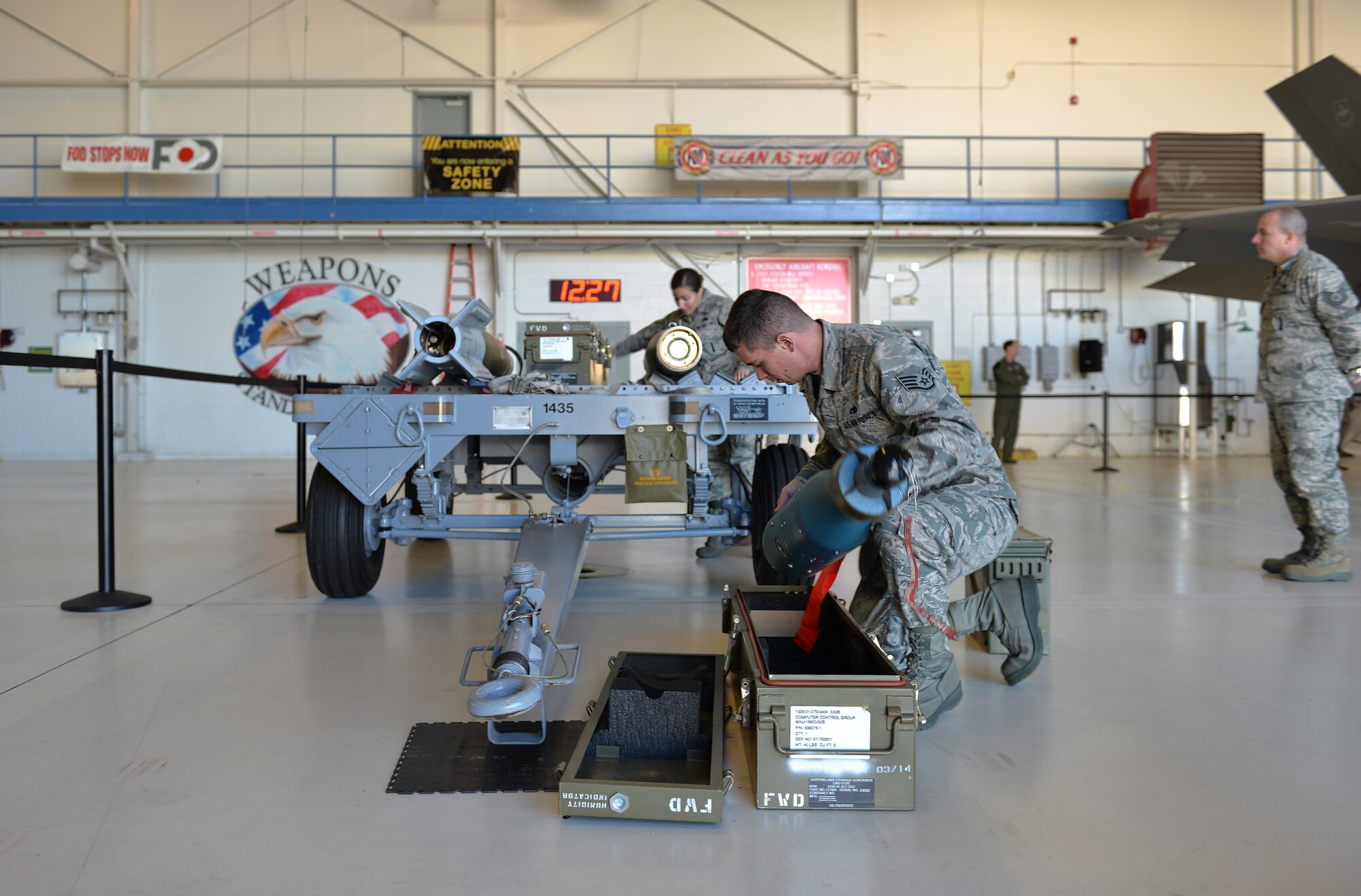 Airman 1st Class Robert Honeycutt, 33rd Aircraft Maintenance Squadron weapons load crew member, and Senior Airman Danielle Gschwendner, 33rd Maintenance Squadron weapons load crew member, prepare a joint direct attack munition for the first annual load competition at Eglin Air Force Base, Fla., Feb. 5. Load crew members worked together to load a missile into an F-35A Lightning II. (U.S. Air Force photo/Senior Airman Andrea Posey)