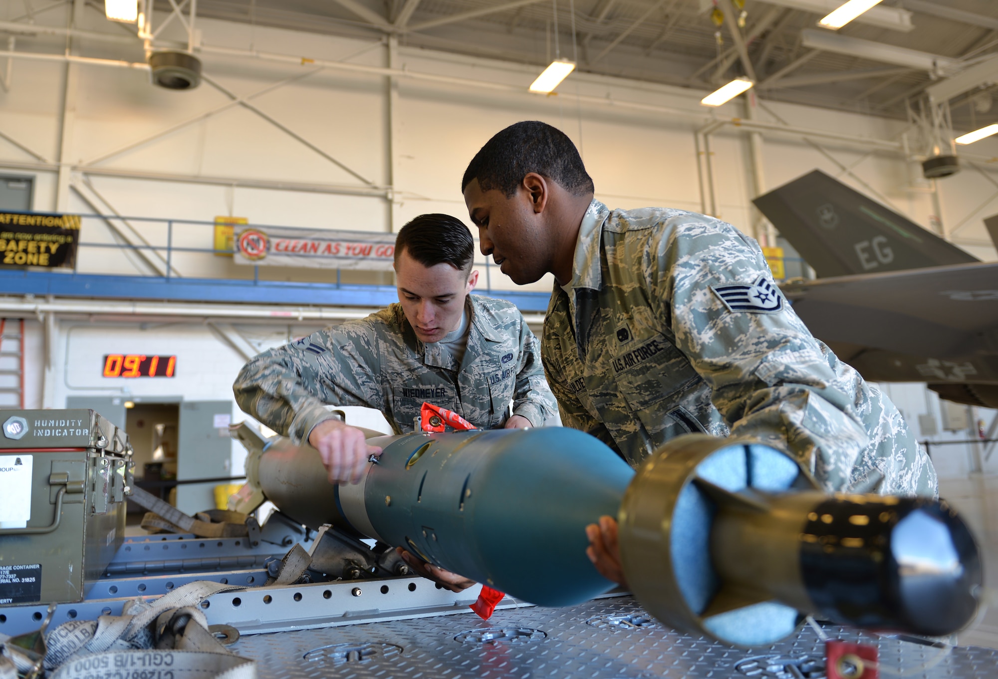 Staff Sgt. Timothy Gaulden, 33rd Aircraft Maintenance Squadron weapons load crew chief, and Airman 1st Class Jacob Robinson, 33rd AMXS weapons load crew member, attach a joint direct attack munition to a missile-guided bomb unit for the first F-35A annual load competition at Eglin Air Force Base, Fla., Feb. 5. During this event Airmen compete in a uniform inspection, a written test, a tool box inspection and an integrated load. (U.S. Air Force photo/Senior Airman Andrea Posey)