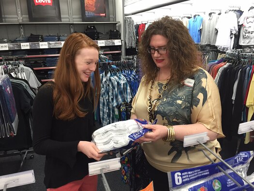 Holly Thill, winner of a $2,000 prize in the Army and Air Force Exchange Service’s worldwide “You Made the Grade” sweepstakes, looks over socks Feb. 5 she may purchase at the Wright-Patterson Air Force Base Exchange store with store manager Christy Beenenga.  (Skywrighter photo/Amy Rollins)