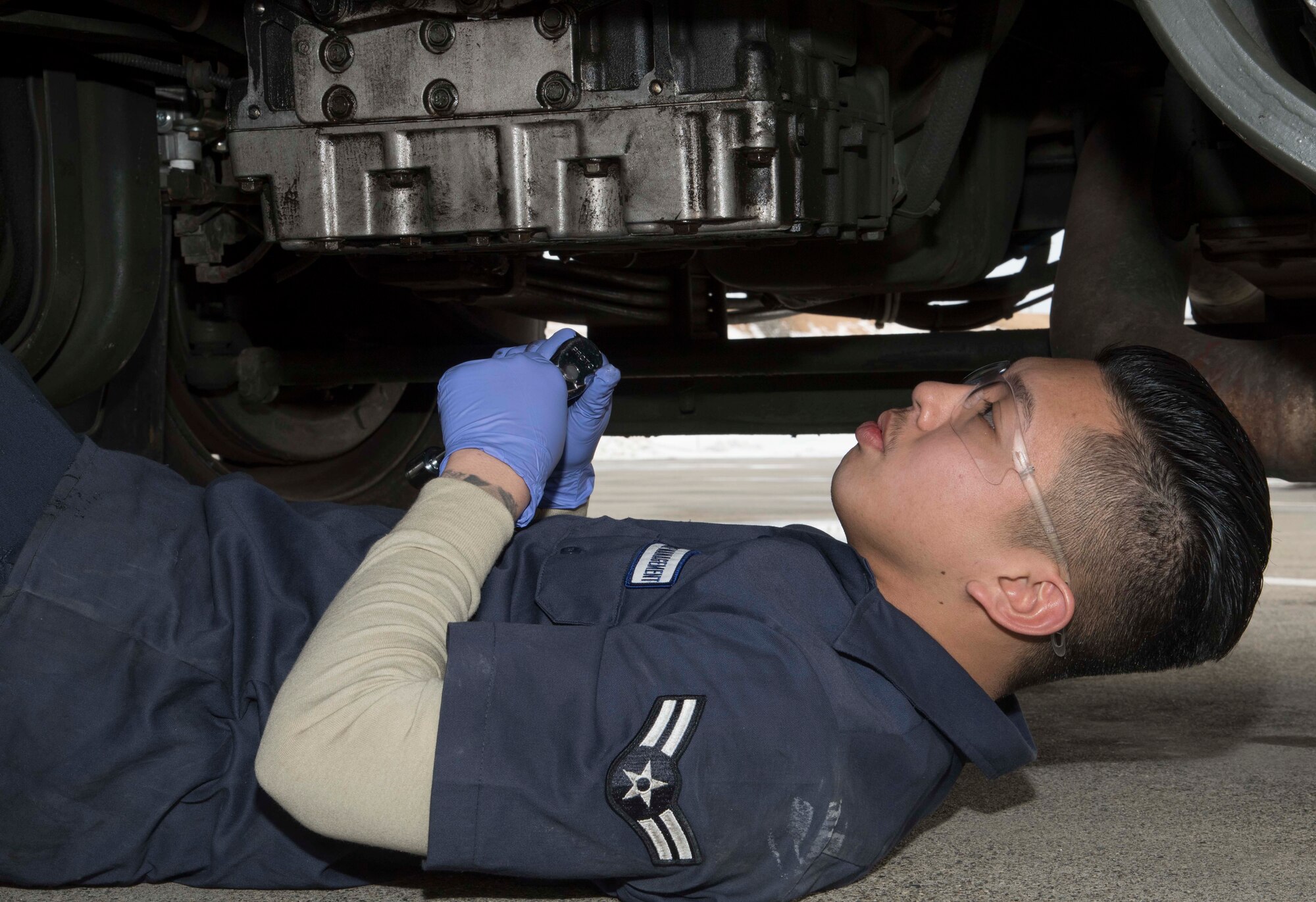 U.S. Air Force Airman 1st Class Derron M. Cordero, a vehicle and vehicular equipment maintenance journeyman with the 35th Logistics Readiness Squadron, works on the underside of an R-11 refueling truck at Misawa Air Base, Japan, Feb. 9, 2016. Cordero performs routine and unscheduled maintenance on military vehicles and equipment to ensure they remain in working order. Cordero is from Stockton, California. (U.S. Air Force photo by Airman 1st Class Jordyn Fetter)