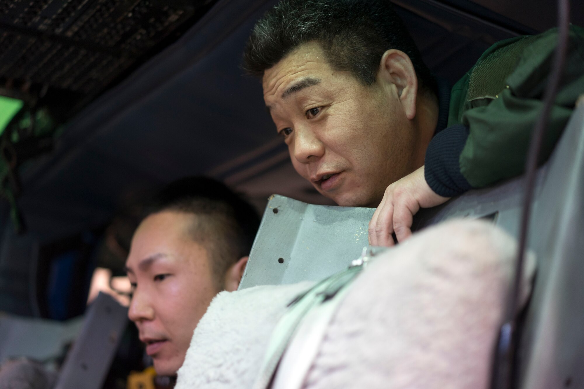 Japan Air Self-Defense Force Air Rescue Airmen from Komatsu Air Base tour a UH-1N Huey at Yokota Air Base, Japan, Feb. 9, 2016. Yokota’s 459th Airlift Squadron hosted a day-long conference for Komatsu Airmen, providing an opportunity to share experiences and knowledge in their respective units. (U.S. Air Force photo by Airman 1st Class Delano Scott/Released)