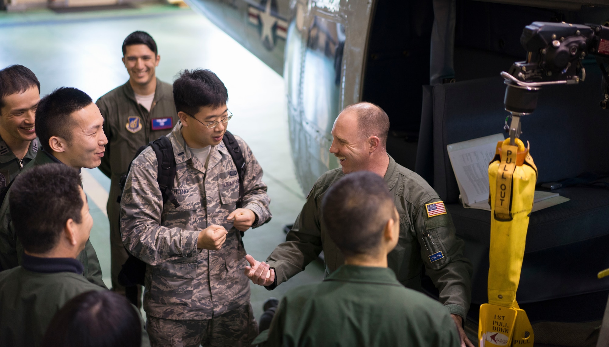 Yokota Airmen brief Japan Air Self-Defense Force Air Rescue Airmen on the capabilities of the UH-1N Huey at Yokota Air Base, Japan, Feb. 9, 2016. The 459th Airlift Squadron hosted a day-long conference with the Komatsu Airmen, providing an opportunity to share experiences and knowledge in their respective units. (U.S. Air Force photo by Airman 1st Class Delano Scott/Released)