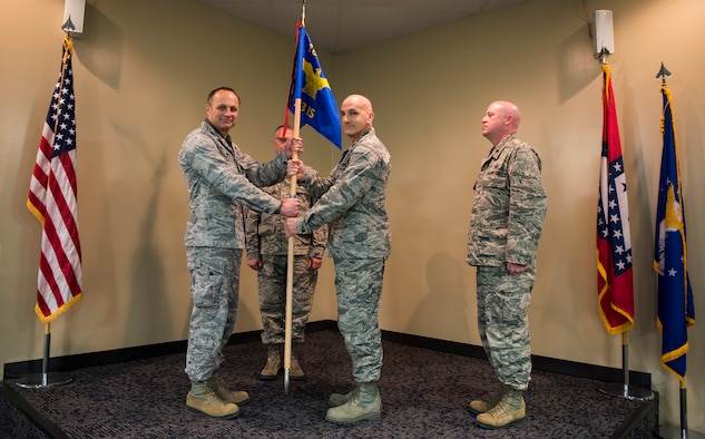 Col. Robert Kenny, commander of the 188th Intelligence, Surveillance and Reconnaissance Group, hands the guidon to Lt. Col. Robert Novak, commander of the 123rd Intelligence Squadron, Feb. 11, 2016 during a change of command ceremony at Ebbing Air National Guard Base, Fort Smith, Ark. Lt. Col. Sonny Stefancic, right, relinquished command of the 123rd IS to Novak and is now the deputy commander of the 188th ISRG. (U.S. Air National Guard photo by Senior Airman Cody Martin/Released)