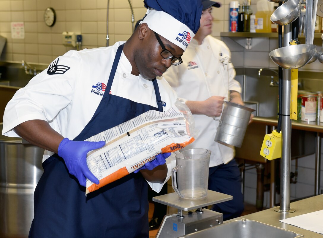 Senior Airman Terrance Hill of the 132d Wing Services Flight, measures rice as a part of the meal preparations, during February UTA . (U.S. Air National Guard photo by Staff Sgt. Matthew T. Doyle/Released)