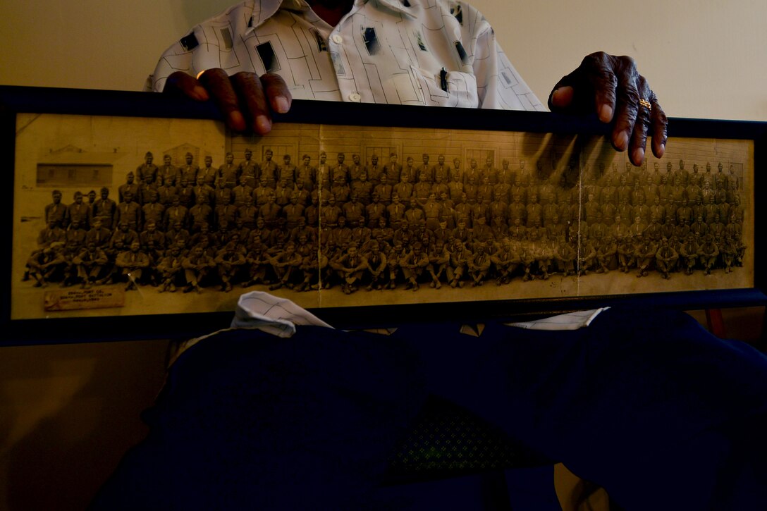 U.S. Army Col. Aaron M. Dotson, a retired World War II and Vietnam War veteran, holds his military training class photo, in his home in Hampton, Va., Aug. 8, 2015. Dotson served in the military for 20 years, during which time he saw many changes throughout the U.S. Army’s social culture. (U.S. Air Force photo by Staff Sgt. Natasha Stannard)