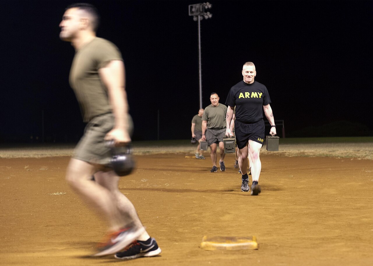 Army Command Sgt. Maj. John W. Troxell, right, senior enlisted advisor to the chairman of the Joint Chiefs of Staff, carries ammo cans during a morning physical training session with sailors and Marines at Camp H.M. Smith, Hawaii, Feb. 10, 2016. DoD photo by Navy Petty Officer 2nd Class Dominique A. Pineiro