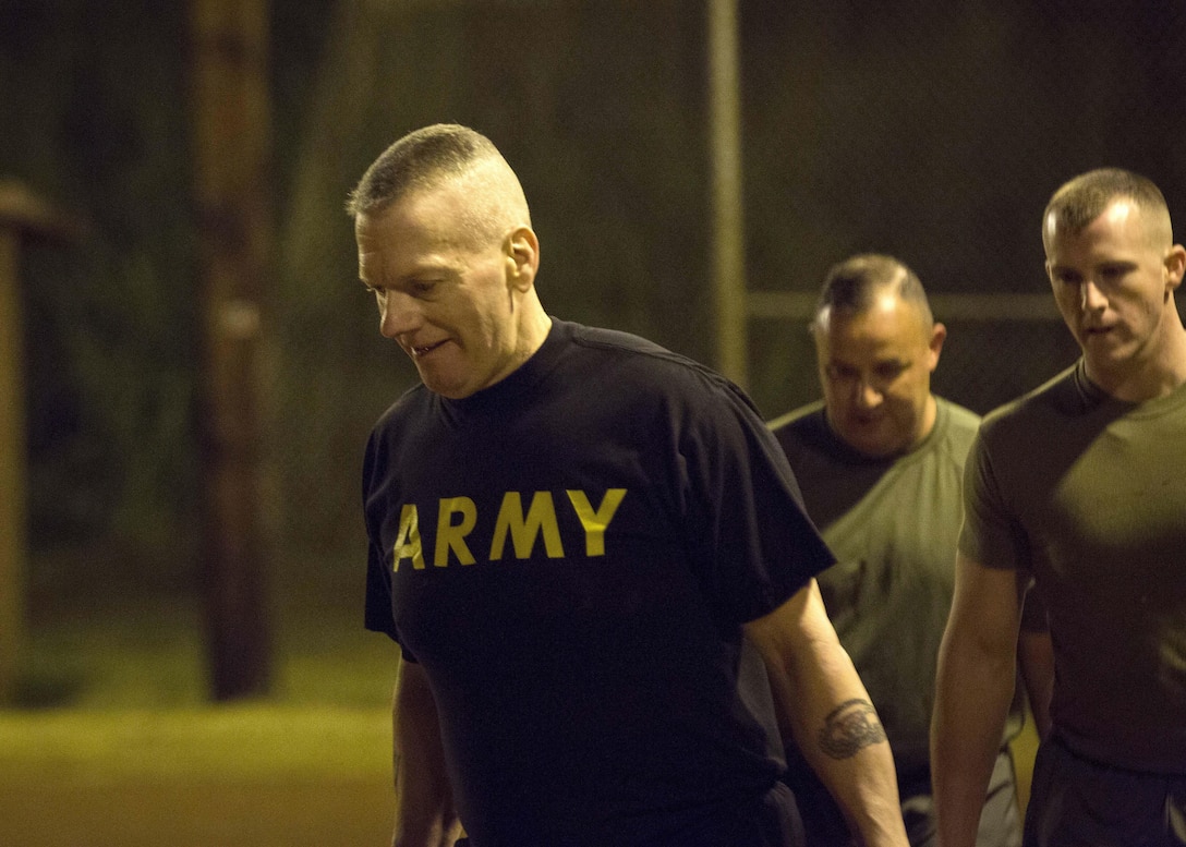 Army Command Sgt. Maj. John W. Troxell, senior enlisted advisor to the chairman of the Joint Chiefs of Staff, carries ammo cans during a morning physical training session with sailors and Marines at Camp H.M. Smith, Hawaii, Feb. 10, 2016. Marine Corps photo by Sgt. Erik Estrada