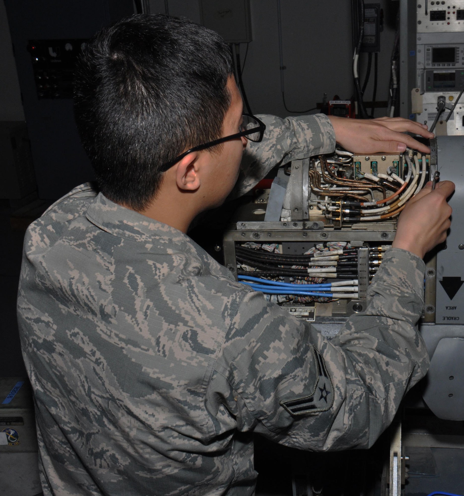Airman 1st Class Long Nguyen, 379th Expeditionary Maintenance Squadron electronic countermeasures technician from Seattle, Washington, tries to find a fluid leak on an electronic warfare attack pod at Al Udeid Air Base, Qatar Feb. 9. Nguyen is part of the avionics flight electronic countermeasures section, which is responsible for maintaining $83 million in equipment. The avionics flight performed 56 maintenance inspections over the past six months. (U.S. Air Force photo by Tech. Sgt. James Hodgman/Released)