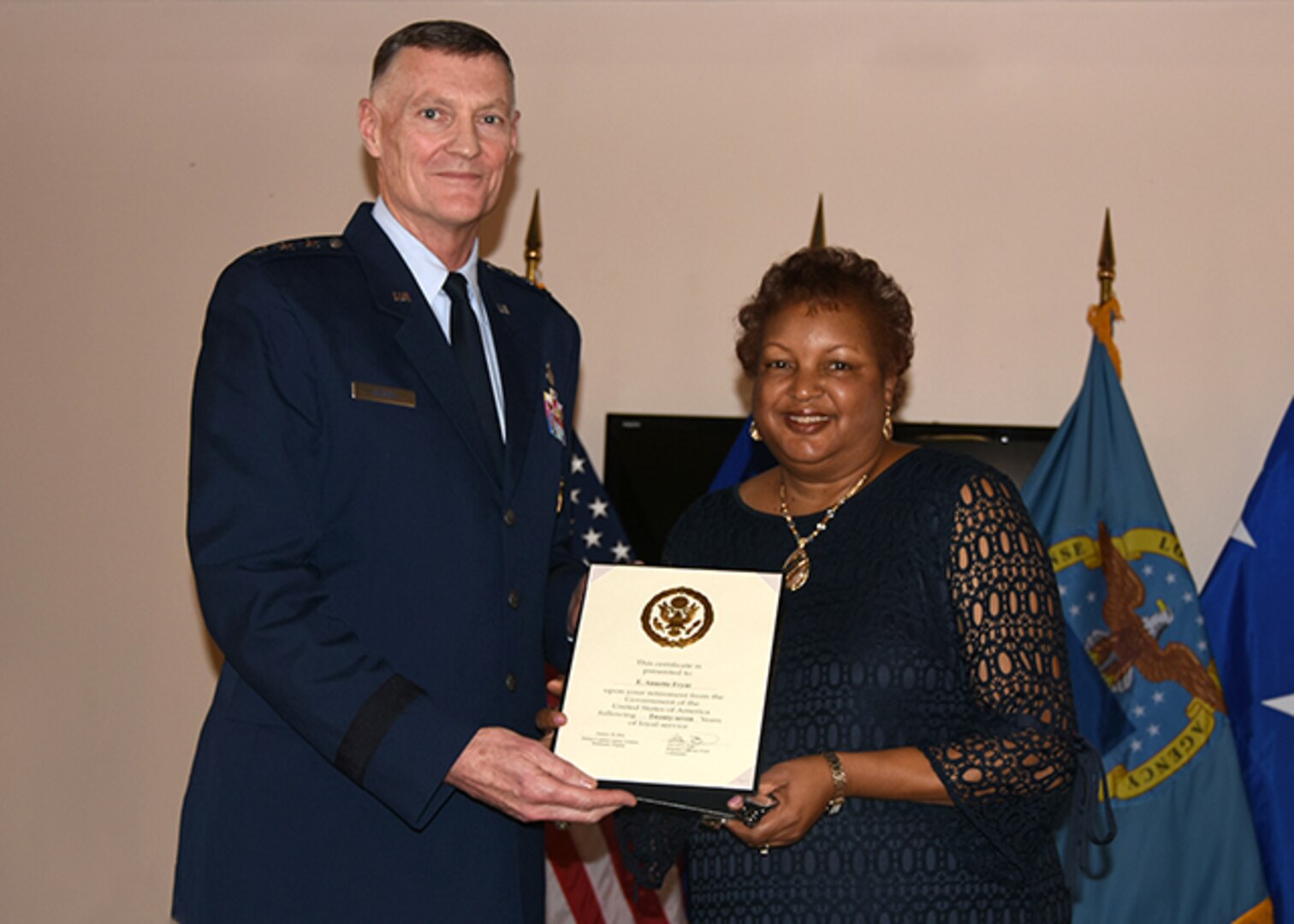 DLA Aviation's Secretary to the Commander Annette Fryar is awarded a certificate of retirement, after 27 years of federal service, from DLA Director, Air Force Lt. Gen. Andy Busch in a ceremony held Feb. 5, 2016 at DLA Aviation's Community Center in Richmond.