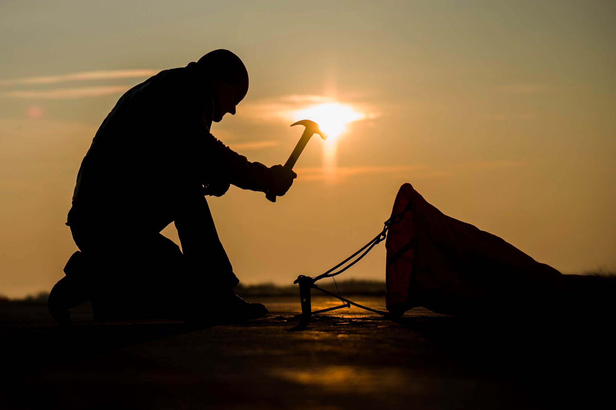 A 321st Special Tactics Squadron combat controller hammers into place a distance marker before the start of an austere landing exercise at Plovdiv, Bulgaria, Feb. 9, 2016. Combat controllers supported the training for multiple aircraft deployed to Bulgaria as part of Operation Atlantic Resolve, which aims to assure the U.S.’s commitment to the security and stability of Europe. (U.S. Air Force photo/Airman 1st Class Luke Kitterman)