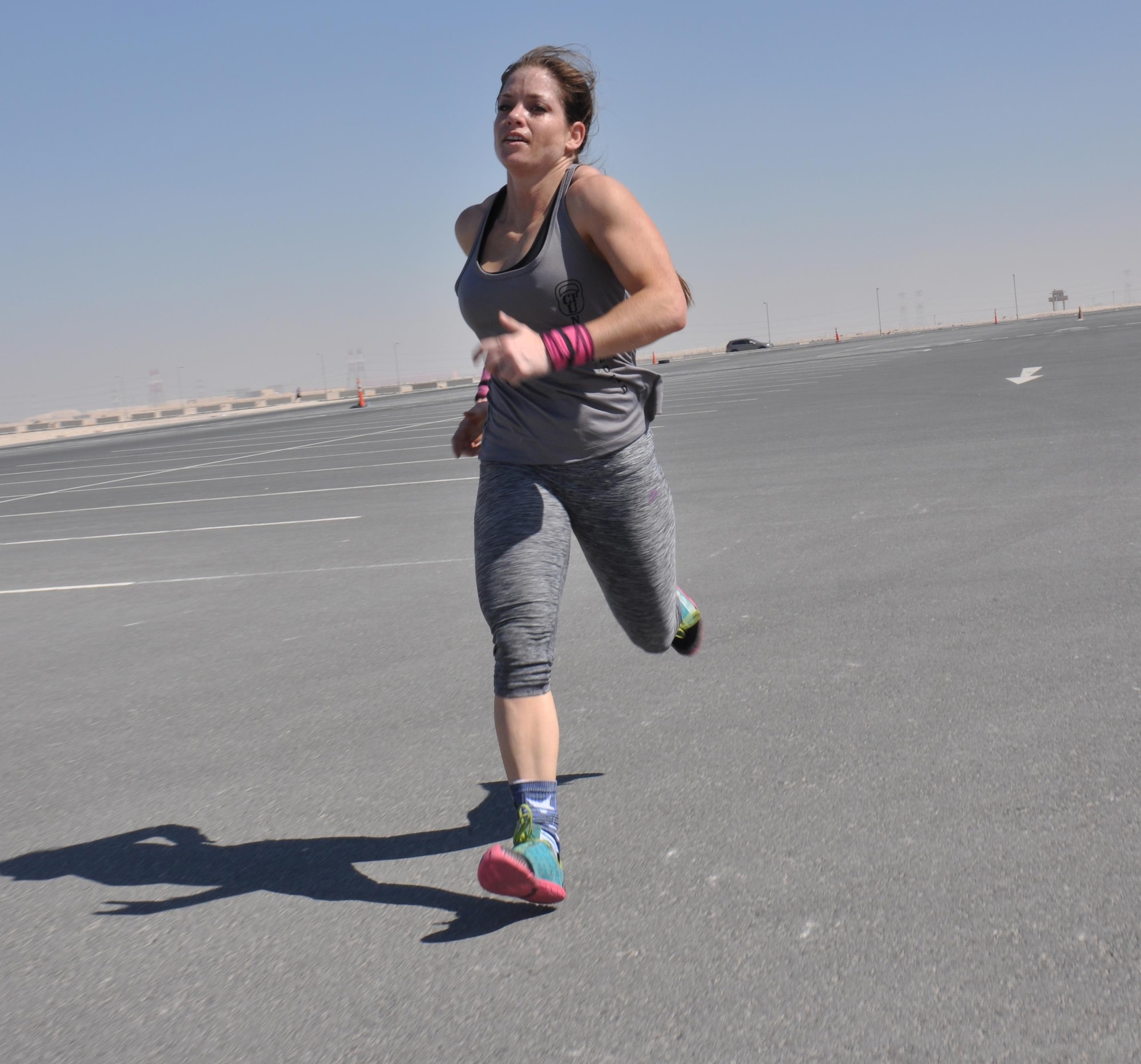 Senior Airman Kendra Lee, Joint Combat Support Command U.S. Central Command Forward Headquarters cyber transport journeyman, sprints to the finish of the Cross Fit Undisclosed Suicide Awareness Workout at Al Udeid Air Base, Qatar, Feb. 6. Lee, a Cross Fit enthusiast, joined more than 100 service members for the event, which was designed to bring more attention to Comprehensive Airmen Fitness with a focus on suicide prevention. (U.S. Air Force photo by Tech. Sgt. James Hodgman/Released)