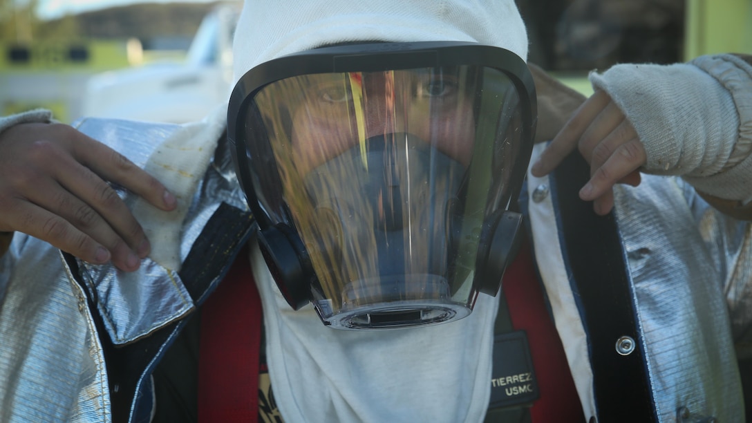 Pfc. Randy Gutierrez, an Air Rescue Fire Fighting turret operator with Kaneohe Bay Marine Corps Air Station, suits up in a fire proximity suit aboard MCAS, Feb. 9, 2016. The mission of ARFF is to protect property and save lives which means the Marines need to be suited up and moving out within seconds of a call. ARFF rescue men work together to prevent aircraft fires, house fires, and any other emergency on the airfield and on base. 
