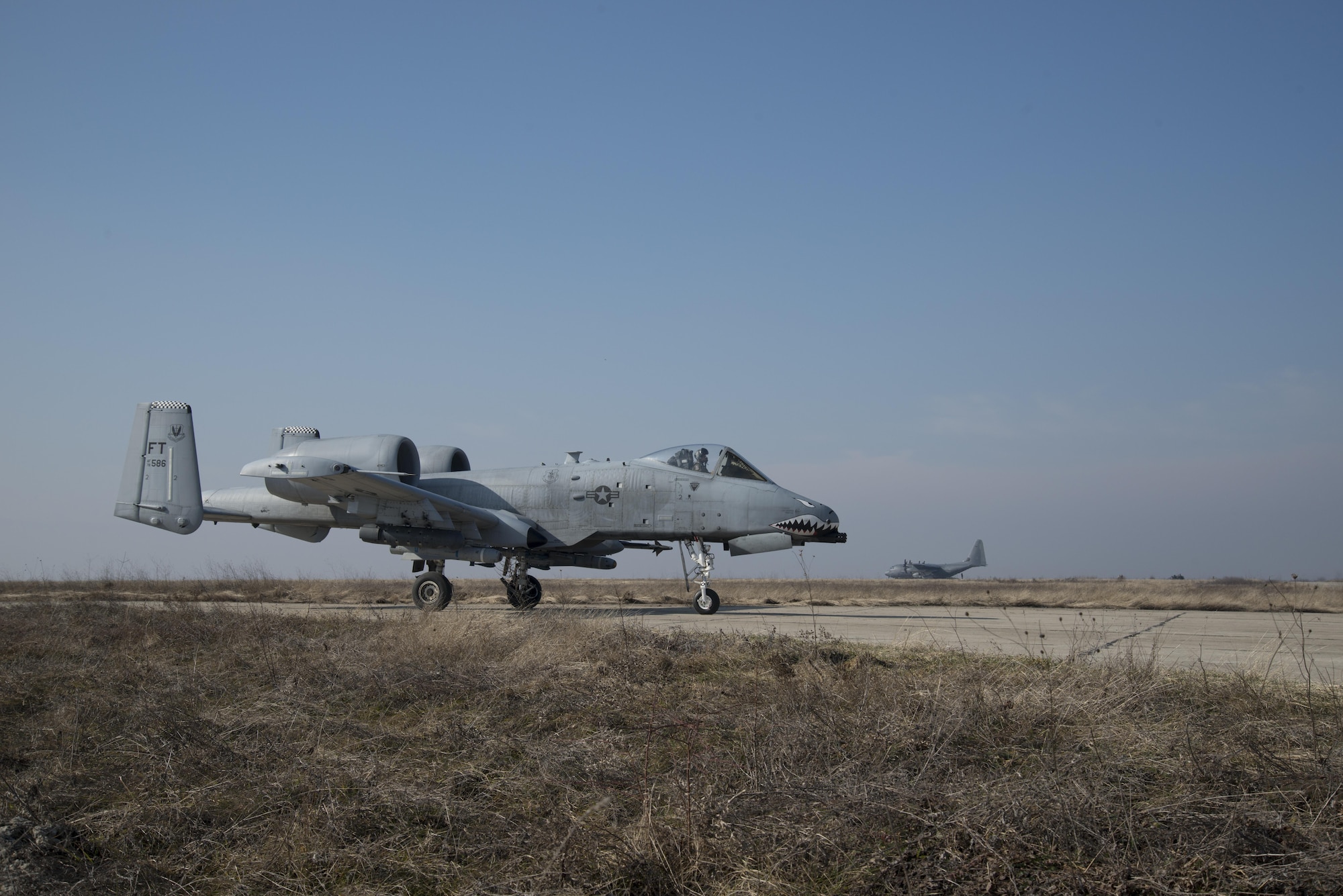 A 74th Expeditionary Fighter Squadron A-10C Thunderbolt II aircraft waits to be refueled by an MC-130J Commando II, from the 352d Special Operations Wing, during forward area refueling point training at Plovdiv, Bulgaria, Feb. 10, 2016. The C-130 can provide tens of thousands of pounds of fuel to multiple aircraft in a matter of minutes both on the ground and in the air. (U.S. Air Force photo by 1st Lt Chris Sullivan/Released)