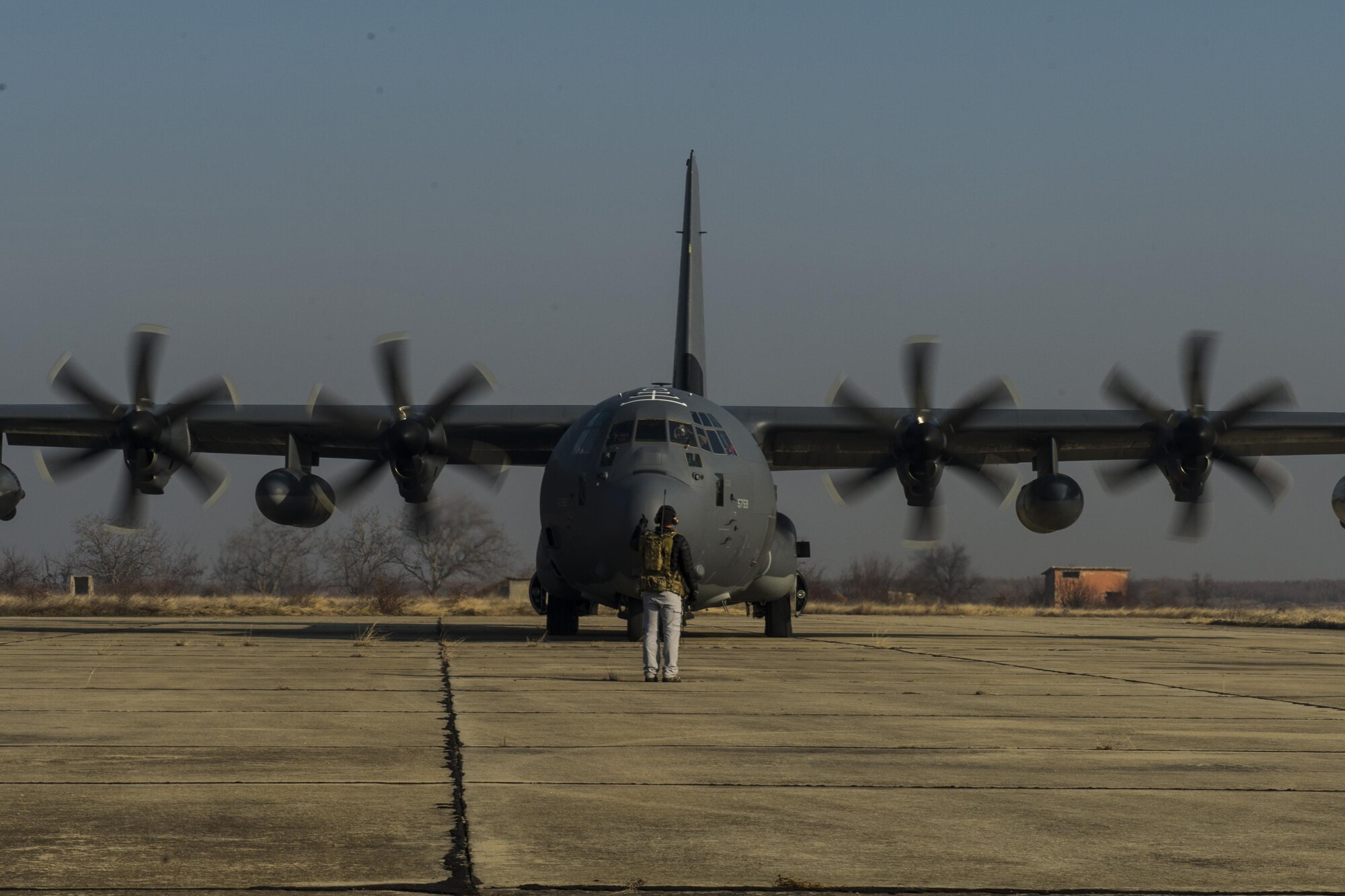 A 352d Special Operations Wing combat controller gives a ‘thumbs up’ after marshalling an MC-130J Commando II aircraft, assigned to the 67th Special Operations Squadron, into position during a training exercise at Plovdiv, Bulgaria, Feb. 9, 2016. The C-130 crew conducted austere landing training along with forward area refueling point training in Bulgaria. (U.S. Air Force photo by Airman 1st Class Luke Kitterman/Released)
