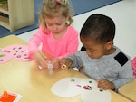 Josie Vickers and Luke Robinson, from the Betty Ackerman-Cobb Child Development Center on Defense Supply Center Richmond, Virginia, design valentines for veterans Feb. 08, 2016 in support of national “Salute to Veteran Patients” week. 