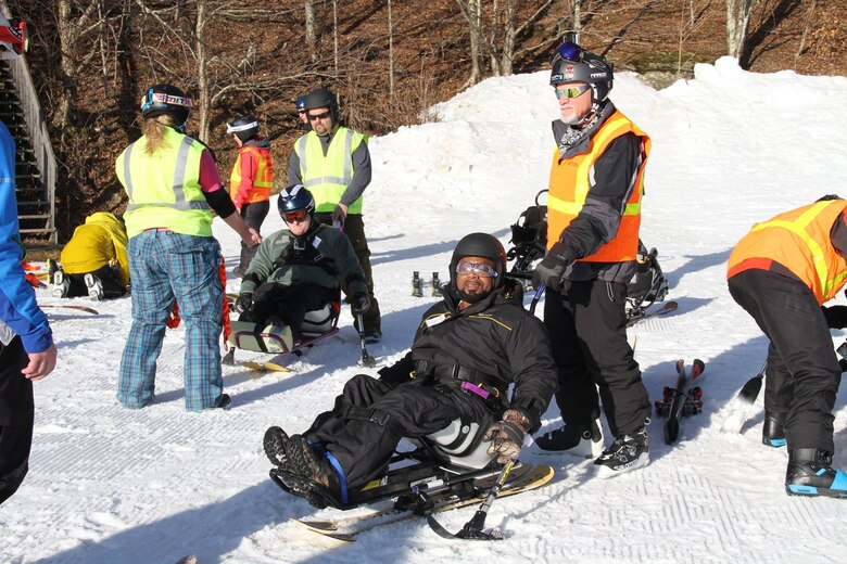 Marcus Brumbaugh, an electrical mechanic from the Nashville District helps skiers during the 35th Disabled Sports USA Adaptive Learn to Ski event clinic held Jan. 19, 2016 at the Beech Mountain Resort in Beech Mountain, N.C. Since 1981, the adaptive sports program has been offering risk reduced and highly supportive ski lessons for adults and children with a wide array of disabilities.     