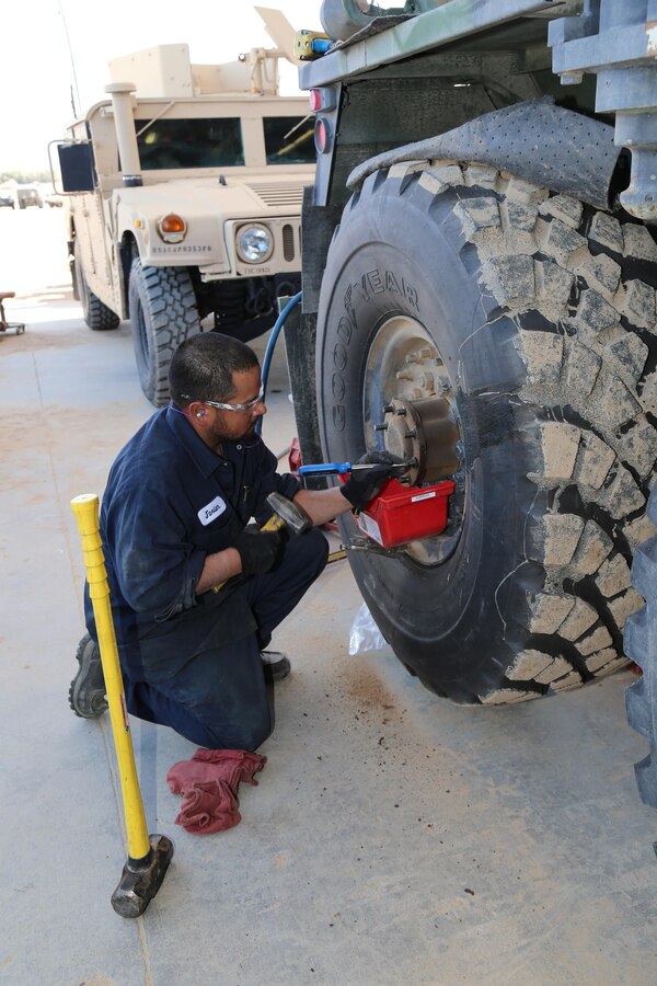 Javier Lopez, heavy mobile equipment repairman with ECS 171, makes fine adjustments to the wheel base of a Hemet Wrecker at ECS 171 aboard Marine Corps Logistics Base Barstow's Yermo Annex, Feb. 4.  ECS 171 employees maintain and store various types of equipment for use by Army units rotating to Fort Irwin for training. 