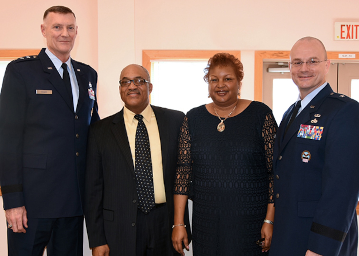 DLA Aviation's Secretary to the Commander Annette Fryar, center right, retired after 27 years of federal service, in Richmond, Virginia on Feb. 5, 2016 in a ceremony held at the Community Center on Defense Supply Center Richmond. Fryar is accompanied by her husband Charles Fryar, center left, DLA Director  Air Force Lt. Gen. Andy Busch, left, who retired Fryar at the ceremony, and DLA Aviation Commander Allan Day, right.