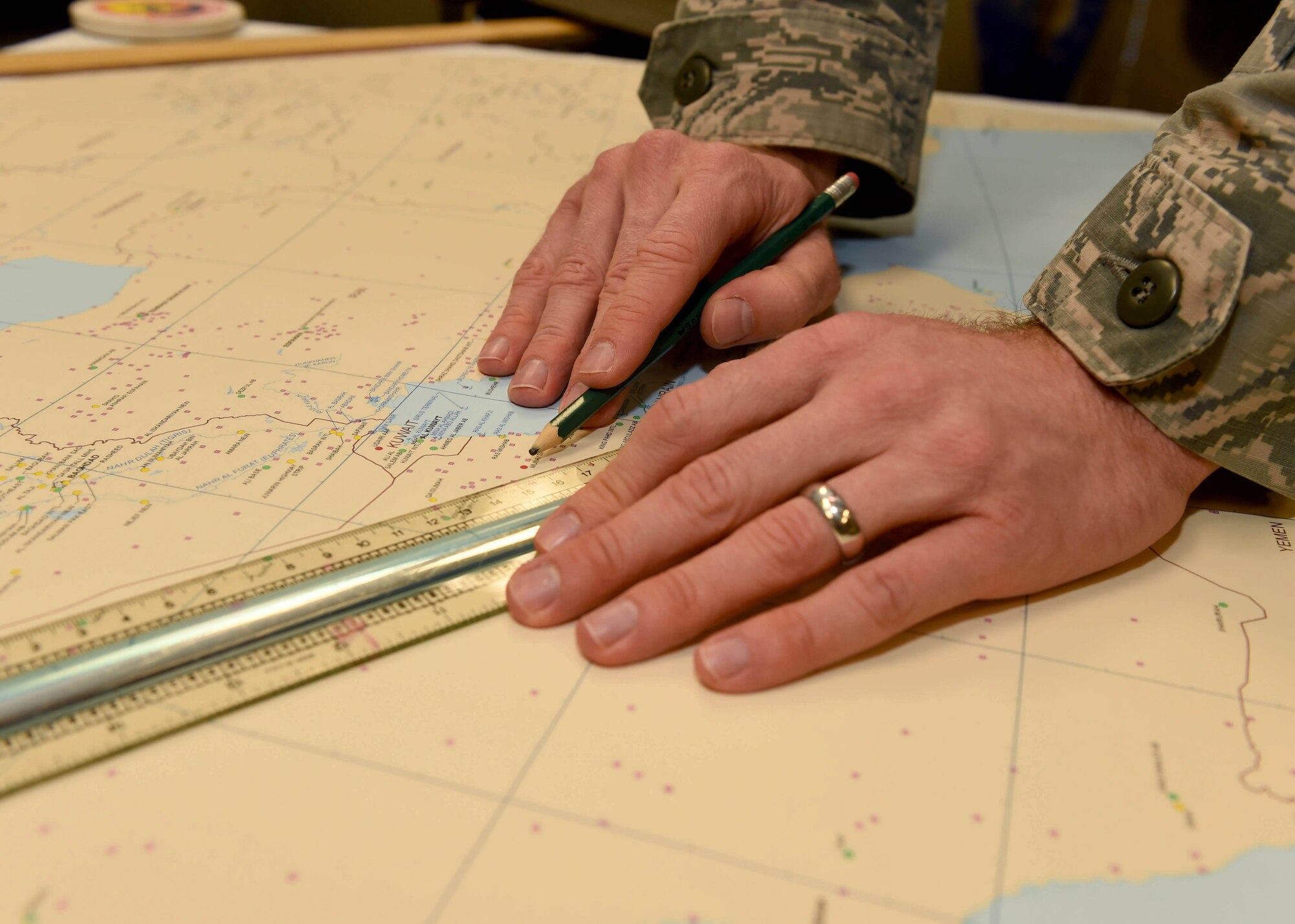 U.S. Air Force Staff Sgt. Marcus Cripe, 97th Operations Support Squadron intelligence flight noncommissioned officer in charge, points out cities and regions on a map at Altus Air Force Base, Okla., Feb. 10, 2016. Intelligence analyst are responsible for collecting, analyzing and reporting key information to make sure Airmen remain safe and missions are successful.  (U.S. Air Force photo by Airman 1st Class Kirby Turbak/Released)