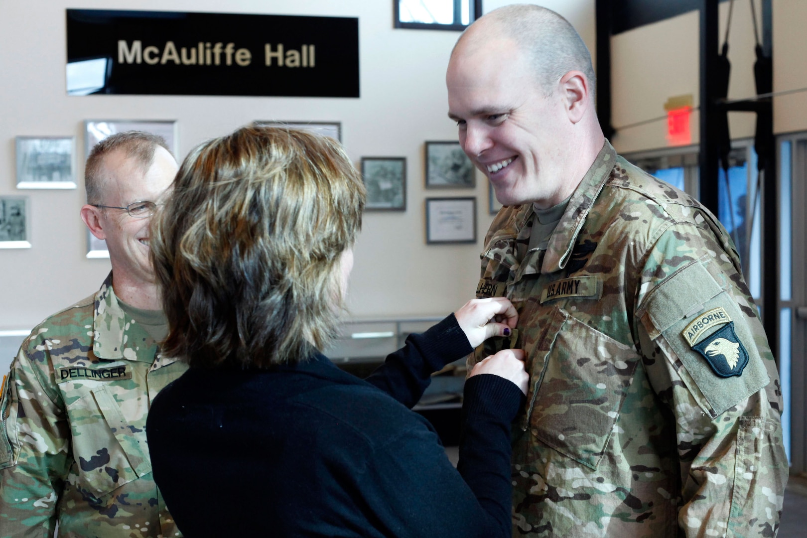 Lt. Col. Cory Mulhern, a liaison officer for the 101st Airborne Division (Air Assault), smiles at his daughter, Sierra, as she pins on his rank during his promotion ceremony in the division headquarters, Fort Campbell, Kentucky, Feb. 11, 2016. Mulhern, a guardsman with the Wisconsin National Guard, is part of the 101st’s multi-component unit, a pilot program where Guard and active duty Soldiers train and deploy together.
