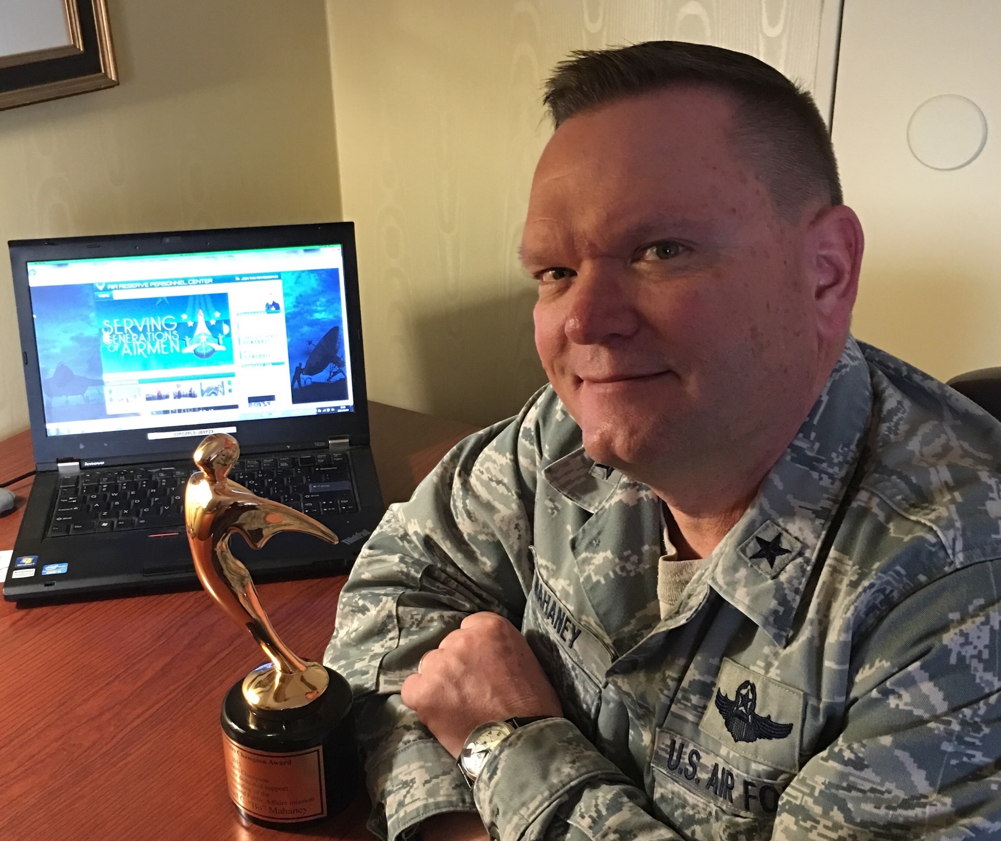 Brig. Gen. Samuel "Bo" Mahaney, Air Reserve Personnel Center commander, sits admiring his Air Force Reserve Command Public Affairs Champion award Feb. 9, 2016. (Courtesy photo: Mrs. Chris Mahaney)