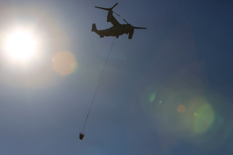 An MV-22B Osprey flies over the training area with the bucket attached in preparation for a water drop aboard Hemet-Ryan Air Attack Base, Calif., Feb. 11. The Marines with Marine Medium Tiltrotor Squadron (VMM) 165 flew out to Diamond Valley Lake on Hemet-Ryan’s Air Attack Base to perform bucket dips in an effort to prove the aircraft was capable of such training while supporting the California Department of Forestry and Fire Protection.