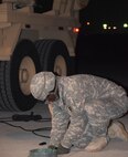 Sgt. Willie Craig, a Patriot launching station enhanced operator/maintainer, assigned to Delta Battery, 1st Battalion, 43rd Artillery Regiment connects cables to a Patriot Launcher System at Osan Air Base, South Korea, Feb. 8. (U.S. Army photo by Capt. William Leasure)