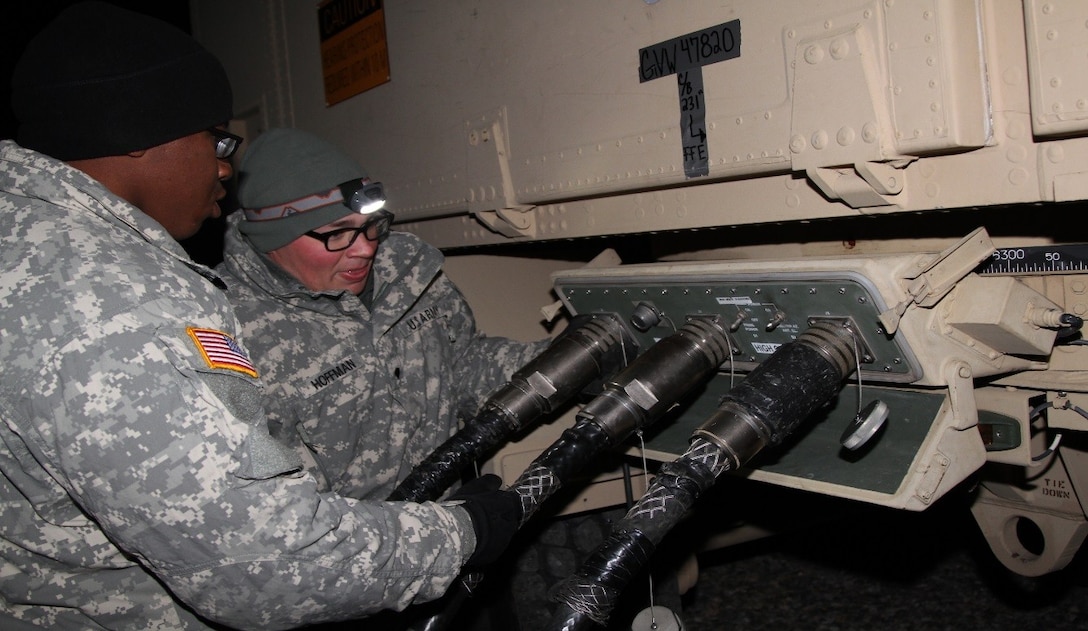 Specialist Tyler Hoffman right, patriot missile operator, and Spc. Deiontay Dawson, network systems operator-maintainer, both with Delta Battery, 1st Battalion, 43rd Air Defense Artillery Regiment assigned to 11th ADA Brigade out of Fort Bliss, Texas, connect power cables to the AN/MPQ-65 radar set during the emplacement phase of their ballistic missile defense exercise, Feb. 8 on Osan Air Base, South Korea. (U.S. Army photo/Staff Sgt. Kelly Carlton)