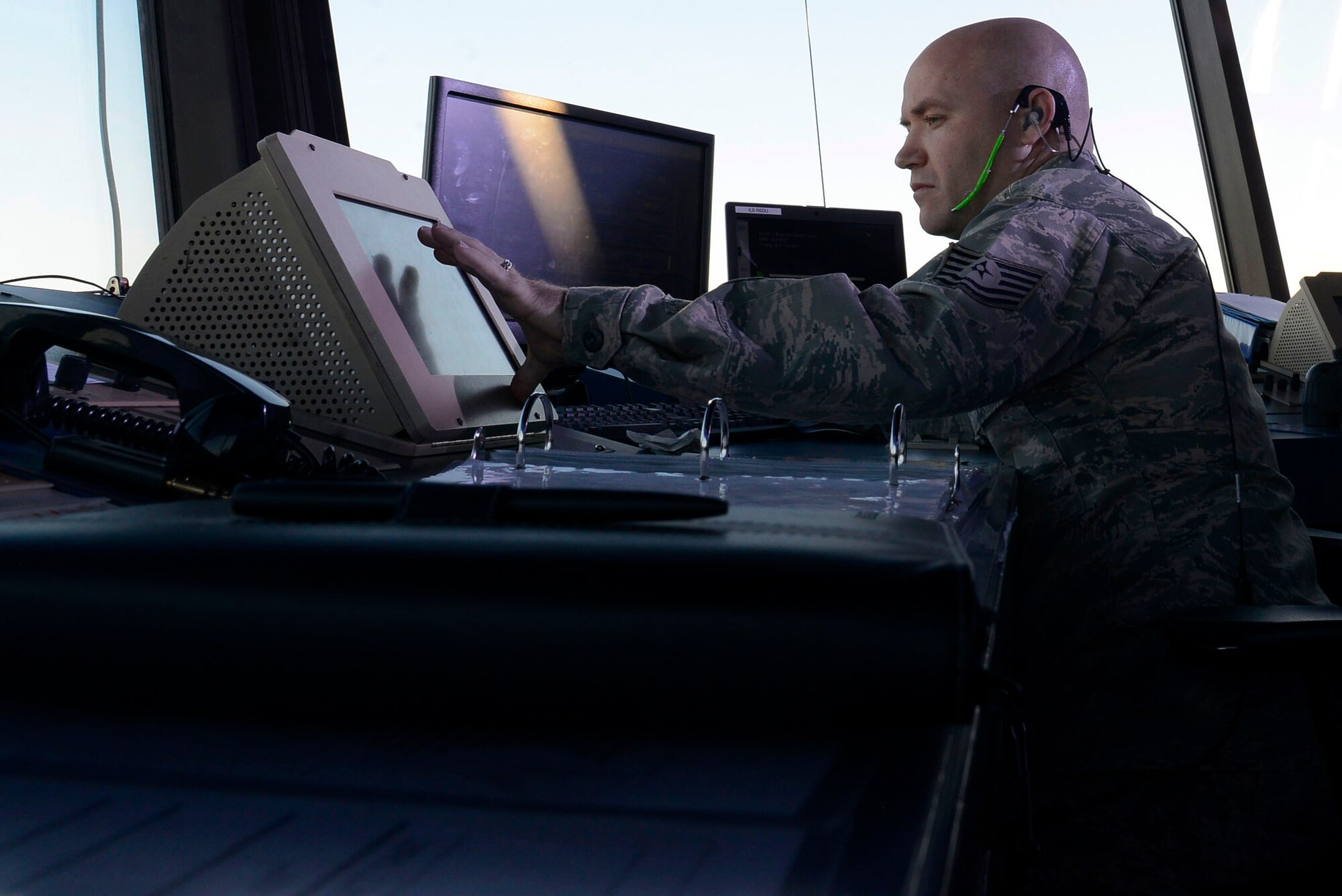U.S Air Force Tech. Sgt. Jason Brumbaugh, 20th Operation Support Squadron air traffic control tower watch supervisor, responds to an alert of birds on the flightline at Shaw Air Force Base, S.C., Feb. 10, 2016. Brumbaugh coordinated with base bird abatement personnel on the flightline to ensure that wildlife do not damage the aircraft. (U.S. Air Force photo by Airman 1st Class Christopher Maldonado) 