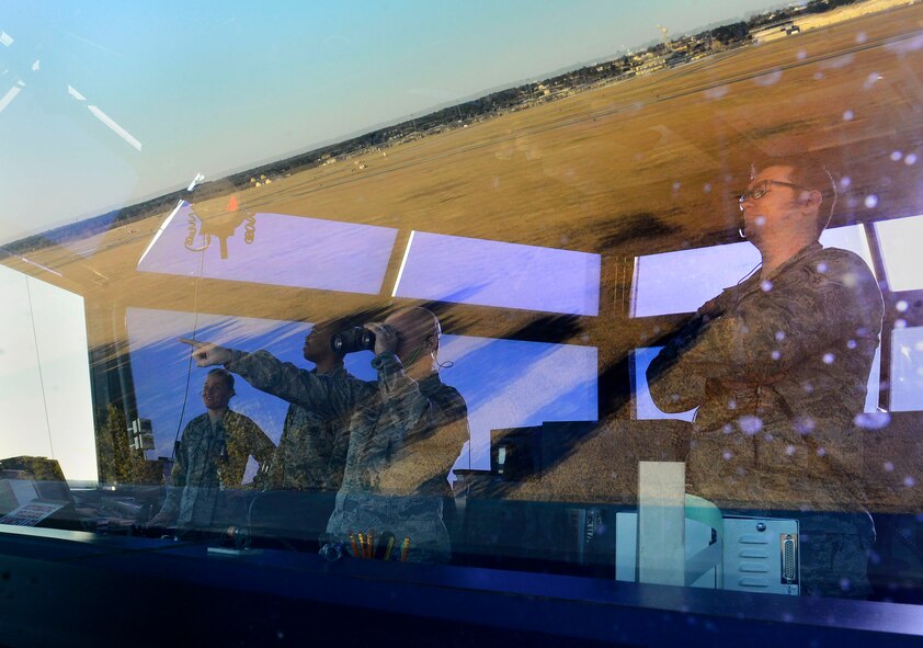 U.S. Airmen assigned to the 20th Operation Support Squadron air traffic control tower observe a flock of birds on the flightline at Shaw Air Force Base, S.C., Feb. 10, 2016. Air traffic controllers have to maintain a constant visual on the flightline to ensure in-bound and out-bound aircraft have no obstacles in their path. (U.S. Air Force photo by Airman 1st Class Christopher Maldonado)