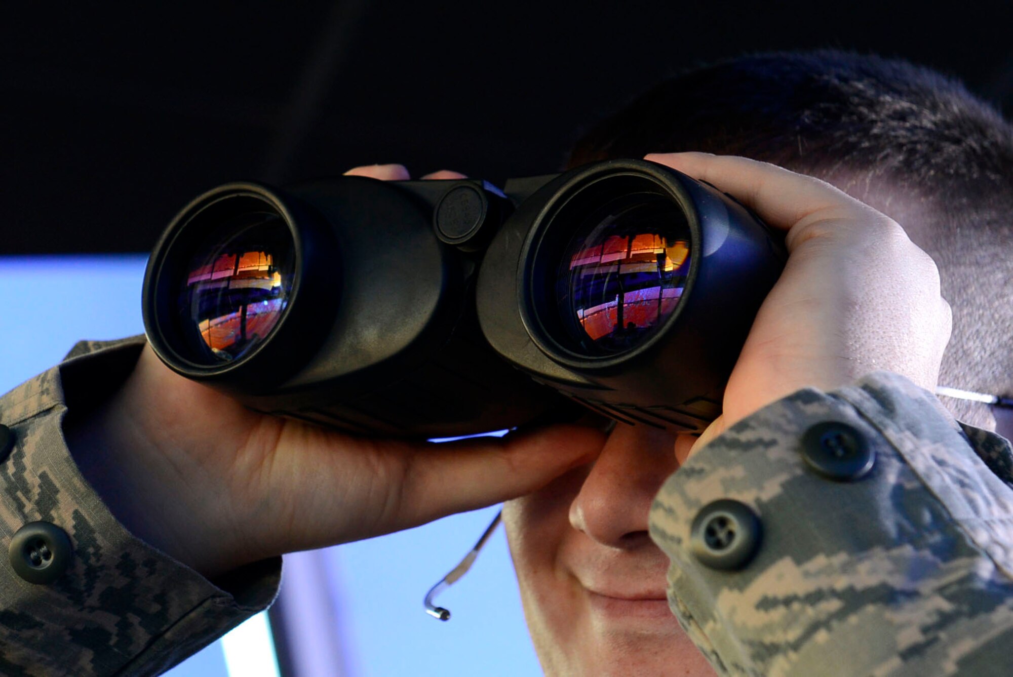 U.S. Air Force Staff Sgt. Phillip Owens, 20th Operations Support Squadron air traffic control tower watch supervisor, scans the flightline for birds that may hinder the landing or departure of aircrafts at Shaw Air Force Base, S.C., Feb. 10, 2016. Airmen assigned to the 20th OSS air traffic control tower oversee a dual-runway airfield and play an integral role in providing a safe operating environment for one of Air Combat Command’s busiest air strips. (U.S. Air Force photo by Airman 1st Class Christopher Maldonado)