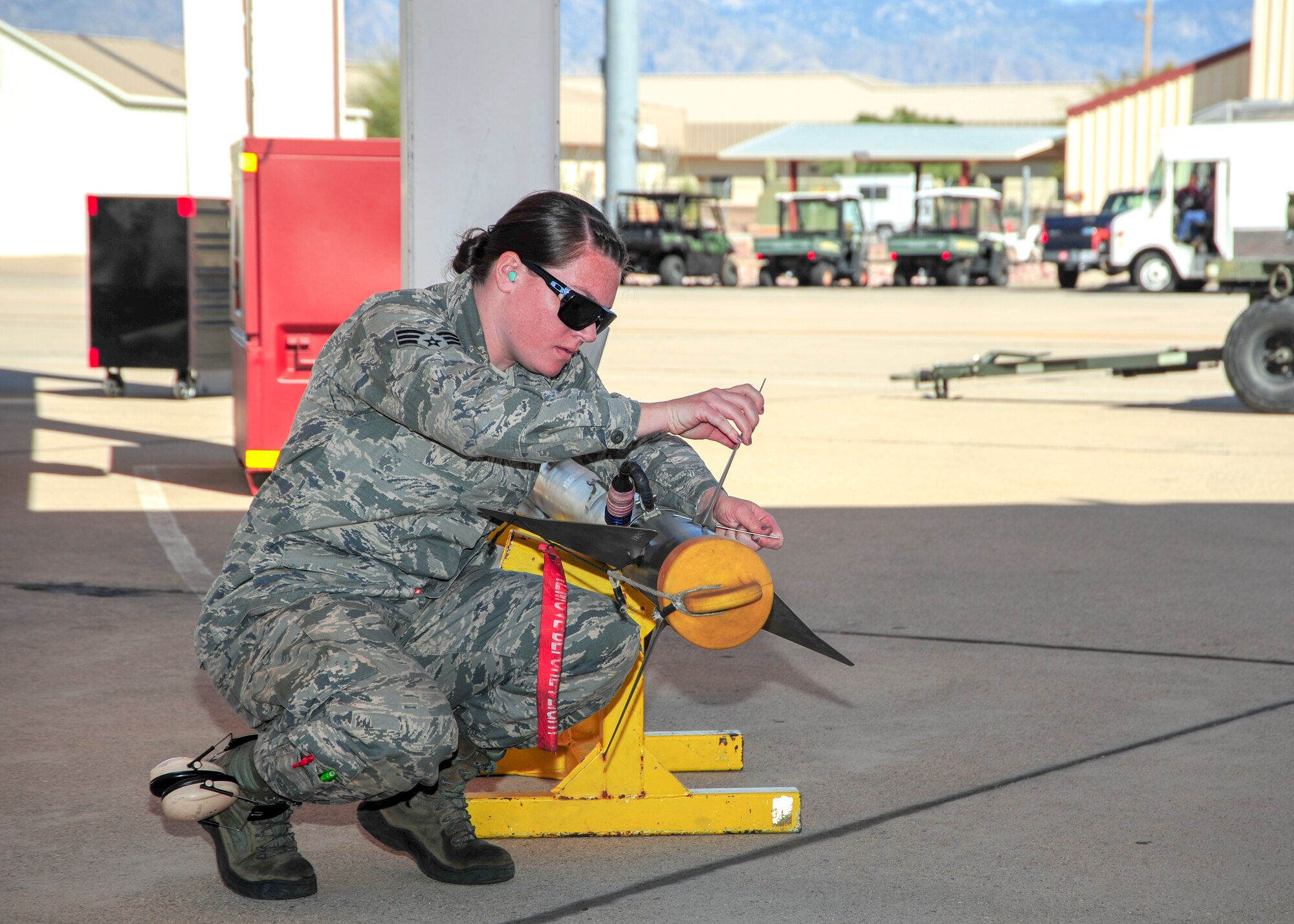 U.S. Air Force Senior Airman Bethany Lamb, 354th Aircraft Maintenance Unit weapons load crew member, prepares an AIM-9 Sidewinder missile to load onto an A-10C Thunderbolt II during a load crew of the year competition at Davis-Monthan Air Force Base, Ariz., Feb. 5, 2016. The load crews were evaluated on timeliness and deficiencies during the contest. (U.S. Air Force Photo by Senior Airman Chris Massey/Released)