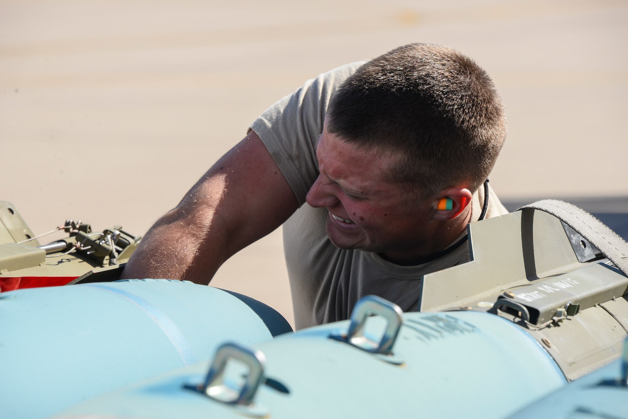U.S. Air Force Senior Airman John Clarke, 355th Aircraft Maintenance Squadron weapons load crew member, prepares an MK-82 Air Inflatable Retarder bomb to load onto an A-10C Thunderbolt II during a load crew of the year competition at Davis-Monthan Air Force Base, Ariz., Feb. 5, 2016. Each of the four load crews competing in the contest consisted of three Airmen who won load crew of the quarter competitions the previous year. (U.S. Air Force photo by Airman 1st Class Mya M. Crosby/Released)
