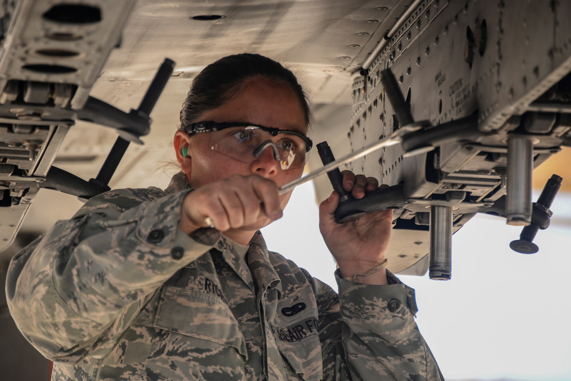 U.S. Air Force Senior Airman Linsie Rice, 355th Aircraft Maintenance Squadron weapons load crew member, prepares to secure a missile onto an A-10C Thunderbolt II during a load crew of the year competition at Davis-Monthan Air Force Base, Ariz., Feb. 5, 2016. The load crews were evaluated on timeliness and deficiencies during the contest. (U.S. Air Force photo by Airman 1st Class Mya M. Crosby)
