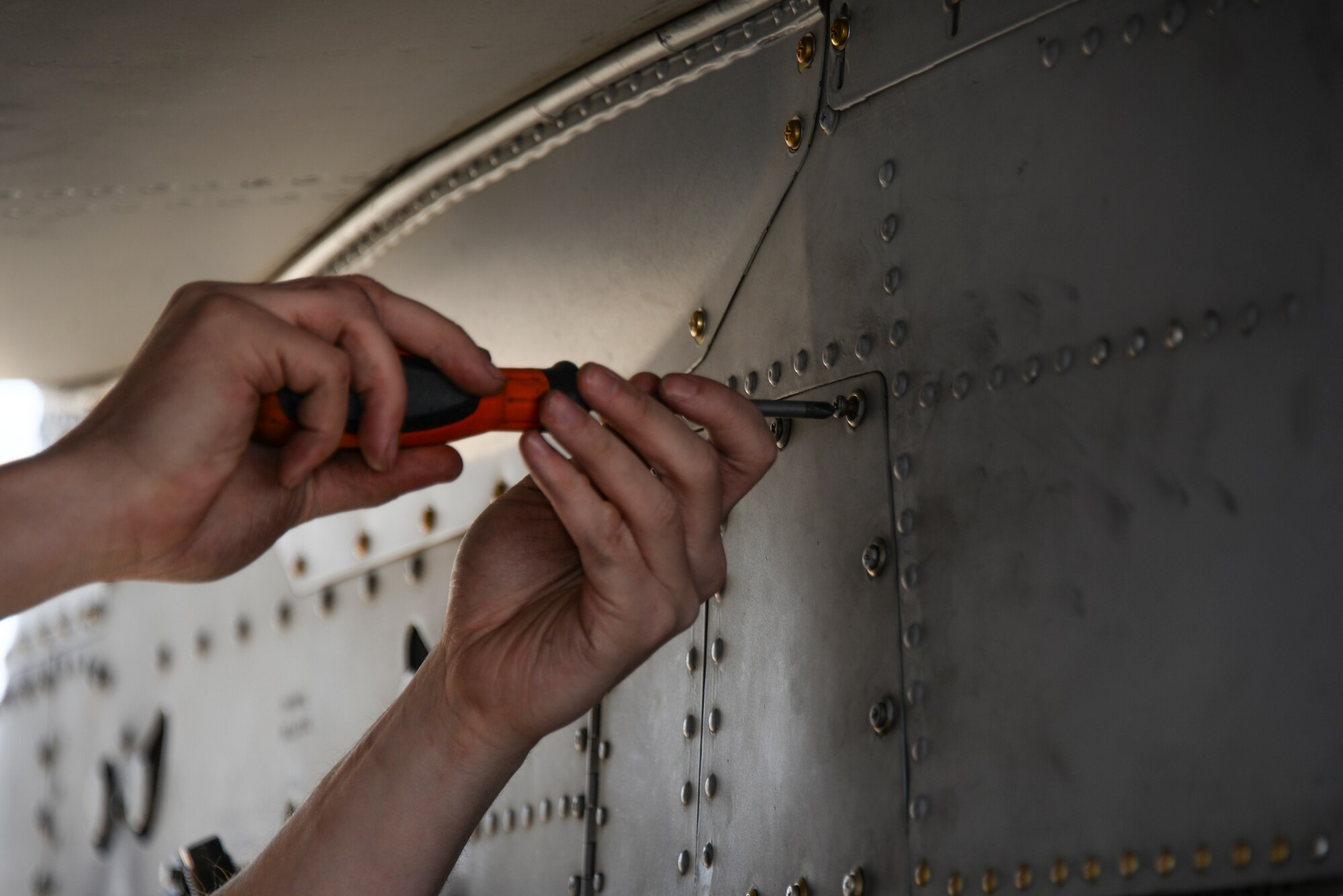 U.S. Air Force Staff Sgt. Seth Bergeron, 355th Aircraft Maintenance Squadron weapons load crew team chief, secures a bolt during a load crew of the year contest at Davis-Monthan Air Force Base, Ariz., Feb. 5, 2016. The load crews were evaluated on timeliness and deficiencies during the contest. (U.S. Air Force photo by Airman 1st Class Mya M. Crosby/Released)